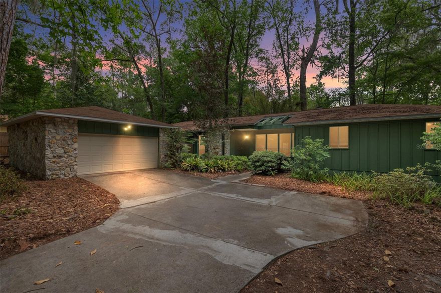 Just a few blocks from UF Law School and main campus! This 4BR/3BA home offers the perfect blend of proximity and peace of mind with a brand-new 2025 roof. The house has 2 separate living areas, with the entryway living area containing a stone fireplace and lots of natural light coming from both front and back of the house.  There's an open kitchen with granite counters, high ceilings, and a functional split-bedroom floor plan. A rare find for this area, the property includes a private 2-car garage and a large fenced backyard with a deck. Whether you're looking for a faculty residence or a high-end campus home, this move-in-ready property is a must-see!