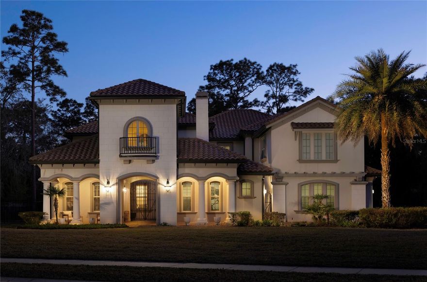 Experience an extraordinary expression of the Florida lifestyle in this commanding estate offering more than 8,600 square feet under roof, gracefully positioned on a premium 1.25-acre homesite within the gated enclave of Bella Foresta. Framed by lush landscaping and designed for exceptional privacy, the residence unfolds as a private resort where architectural elegance and alfresco living exist in seamless harmony.

A dramatic spiral staircase and immediate views of the shimmering pool create a breathtaking introduction. The executive office, richly appointed with custom built-ins, offers a refined work-from-home retreat. In the great room, a cast stone fireplace anchors one side while a dedicated media feature enhances the other, all seamlessly connected to the outdoor living and dining terraces, summer kitchen, and resort-style pool beyond.

Crafted for elevated entertaining, the outdoor environment rivals that of an exclusive retreat. A fully equipped summer kitchen sets the stage for open-air culinary experiences, while the pool house—complete with a full bar and bath—creates an ideal venue for hosting on any scale. A dedicated pool bath and outdoor shower further enhance the effortless indoor–outdoor lifestyle that defines this remarkable property.

Adding a rare layer of flexibility and privacy, the attached guest house offers its own bedroom and full bath, complemented by a private entry. With immediate access to both the garage and the charming front courtyard, this self-contained retreat is perfectly suited for extended family, visiting guests, or a private studio or executive suite—thoughtfully integrated yet distinctly independent.

The owner’s suite serves as a serene sanctuary of impressive proportions, complemented by a spa-inspired bath and an expansive walk-in wardrobe. At the heart of the home, the chef’s kitchen blends professional performance with timeless sophistication, showcasing Sub-Zero refrigeration, Wolf cooking appliances, a generous center island, breakfast bar seating, and a walk-in pantry designed to support both daily living and grand entertaining.

Ascending via the grand front staircase or secondary staircase near the family room, the upper level reveals a gaming loft and purpose-built home theater, creating a private entertainment wing. Two additional bedroom suites, a study area, a fourth bedroom, and a full bath complete the second floor, while wrought-iron railings and oversized picture windows bathe the gallery in natural light.

A comprehensive camera system and standby generator ensure modern peace of mind. Ideally located just minutes from the 417 and 429 beltways, boutique shopping and fine dining in Lake Mary and Sanford, scenic nature trails, and Wilson Landing Park with direct access to the Wekiva River, this estate offers the rare convergence of seclusion, sophistication, and everyday convenience within one of the area’s most distinguished gated communities.