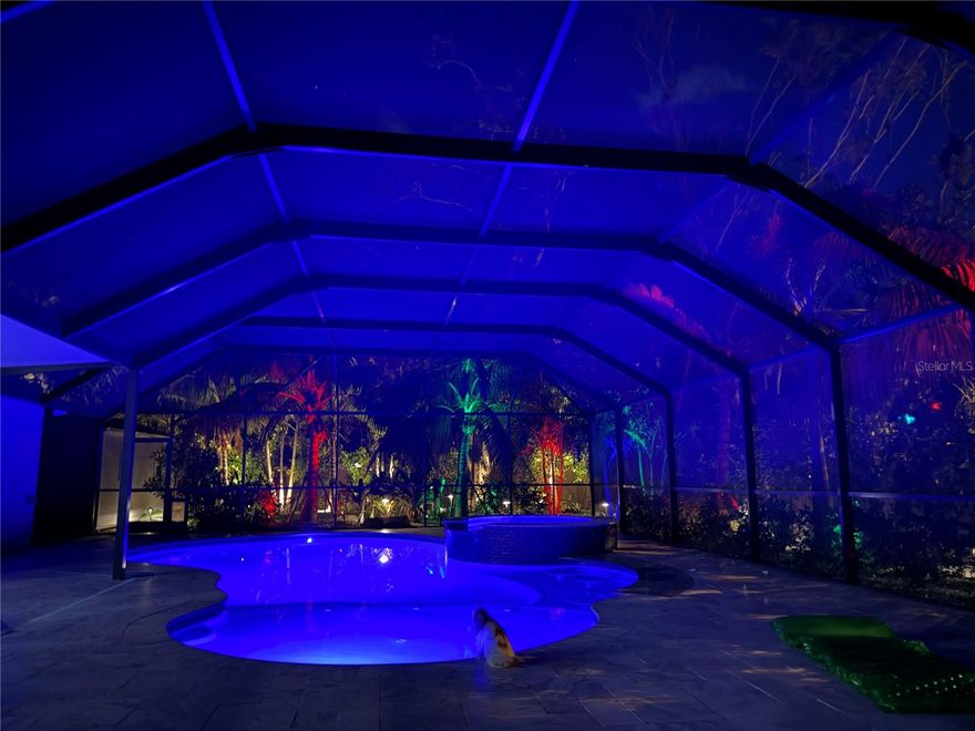 Welcome to 4735 Riverwood Circle, an extraordinary Sarasota retreat where luxury, comfort, and privacy come together in perfect harmony. Tucked away on a serene private corner lot, this home captures the essence of Siesta Key-style living, without Siesta Key prices. Every inch of this property has been meticulously upgraded with high-end finishes, professional landscaping, and premium systems, resulting in a residence that feels like a private resort.

From the moment you arrive, you’re greeted by manicured tropical landscaping, mature and exotic palms, and a stately gated entrance that sets the tone for what’s to come. Step through the gate and into your own personal oasis,a masterpiece of design and function with more than $600,000 invested in landscaping, hardscaping, and a one-of-a-kind outdoor living experience.

At the heart of it all lies a brand-new 10-foot-deep saltwater pool, one of the only true deep-water residential pools in the area. Crafted with travertine decking, in-pool dining and seating areas, and surrounded by lush artificial turf for a maintenance-free experience, this space is as breathtaking as it is functional. The pool is powered by an advanced Hayward system, including a state-of-the-art heater and controller—all still under warranty—giving you effortless control over temperature, lighting, and features. Above it all, the elite roof system keeps the covered patio up to 15 degrees cooler, ensuring year-round enjoyment no matter the Florida heat.

As the sun sets, the property transforms into a tropical dream. Luxury landscape lighting accentuates the palms and pebble pathways, while the automated mosquito misting system ensures every evening is as comfortable as it is beautiful. A new irrigation well supports the lush grounds, designed with Mexican beach pebbles, vibrant greenery, and a mix of native and exotic palms that rival Sarasota’s finest estates.

Inside, the attention to detail continues. The spacious open-concept layout flows seamlessly through each room, creating an inviting atmosphere perfect for both entertaining and everyday living. Elegant Spanish tile flooring adds warmth and charm, complemented by crown molding throughout and hurricane-rated windows in the master suite for peace of mind. Every major system in the home has been replaced or upgraded, including brand-new sewer lines, a new electrical panel, new hot water heater, and new air conditioning system. The attic has been completely re-insulated with pest-resistant material for added efficiency, and the roof, replaced in 2020, comes complete with new gutters.

Even the garage reflects the home’s level of quality and care—it’s been fully finished and outfitted with a professionally sealed epoxy floor in a sleek blue tone, giving it a clean, modern aesthetic. A custom-built luxury shed, valued at over $12,000, provides additional space for tools, hobbies, or storage without compromising the property’s elegance.

The fencing and gates—vinyl in the back for privacy and aluminum in the front for curb appeal—enclose this residence in total tranquility. Every outdoor element has been designed for beauty, function, and low maintenance, allowing you to spend more time enjoying your surroundings and less time maintaining them.

Opportunities like this are rare.  Schedule your private showing today and experience the unmatched elegance, comfort, and peace of mind that make this home truly one of a kind.