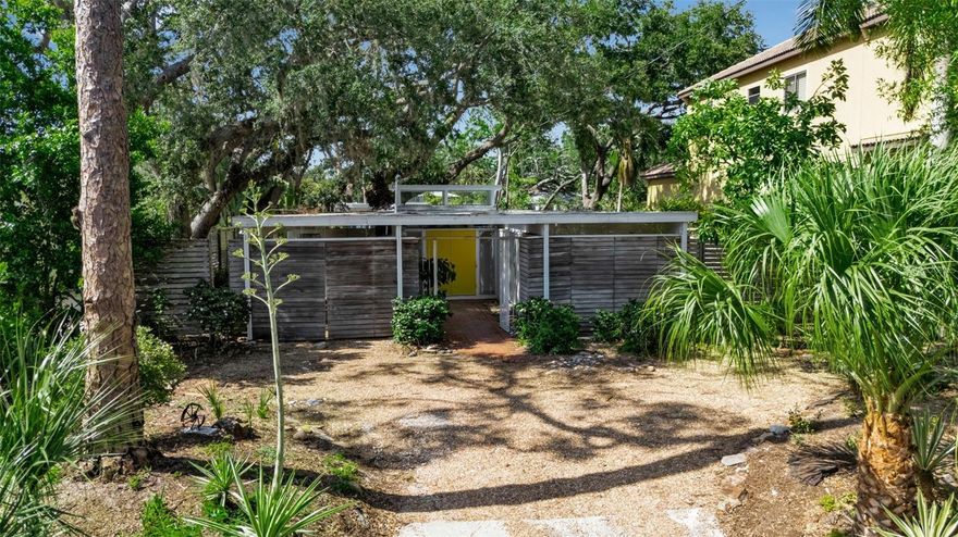 Offered for the first time in decades, the iconic Warriner Home presents a rare opportunity to own a piece of Sarasota’s architectural legacy. Designed in 1960 by renowned husband-and-wife architects Joan and Ken Warriner, this exceptional mid-century modern residence was nationally recognized in Architectural Record Magazine’s prestigious annual feature, "Record Houses of 1961". The home was titled “Good Design on a $14,500 Budget”, a testament to the Warriners' ability to merge timeless design with thoughtful functionality. Located in the vibrant heart of Southside Village, just minutes from downtown Sarasota and the bayfront, this three-bedroom, two-bath home remains remarkably intact, preserving its original architectural integrity. Authentic jalousie windows, pocketed sliding glass doors, and polished terrazzo floors reflect the purity of the mid-century aesthetic, while walls of glass invite an abundance of natural light, blurring the lines between indoor and outdoor living. Sited on a large lot, the property offers ample space to create a private outdoor oasis or add a custom pool and separate guest quarters. Surrounded by mature landscaping and gracious oaks and nestled in one of Sarasota’s most desirable neighborhoods, the home is a peaceful retreat within walking distance to cafés, boutiques, and local restaurants. Whether you are a mid-century purist or a design enthusiast seeking a canvas for tasteful restoration, the Warriner Home stands as a rare and important architectural treasure—ready to inspire its next steward.