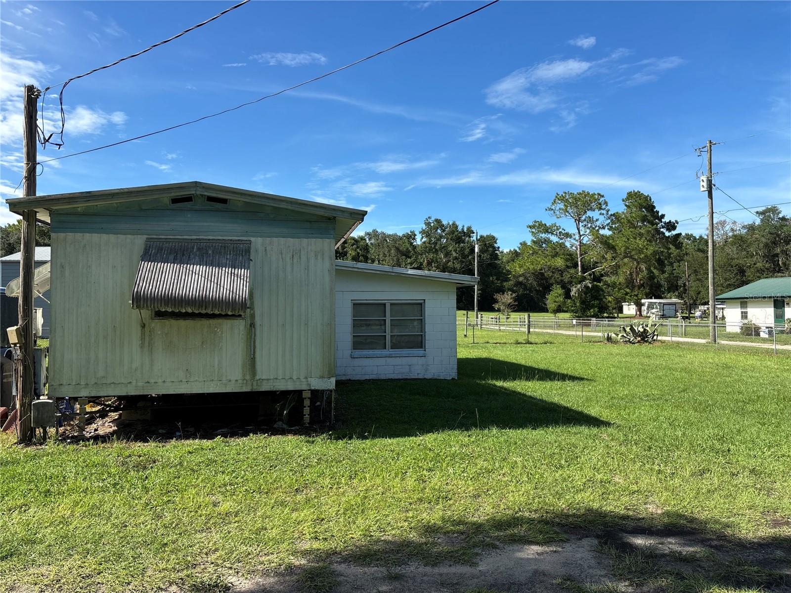 Charming Mobile Home – No HOA!--Affordable Florida Living on Private, Fenced Half Acre –
Welcome to 4636 S Lovering Pt, Inverness, FL, where peaceful country living meets unbeatable value. Priced at just $99,000, this 2 bedroom, 2 bath mobile home offers comfort, space, and privacy on a little over half an acre of fully fenced land – and it's NOT in a mobile home park! This home features a huge sunroom, perfect as a grand master suite or bonus living area, plus a solid block garage with space for a small car and includes the washer and dryer. The newer AC system is built for larger units, offering strong, efficient cooling throughout the home and sunroom. Enjoy no HOA, no pet restrictions, and the freedom to live how you want. Located in a quiet, friendly neighborhood with great neighbors, this property is a rare find for those seeking space and privacy without breaking the bank. Needs a little love, but the potential is incredible!