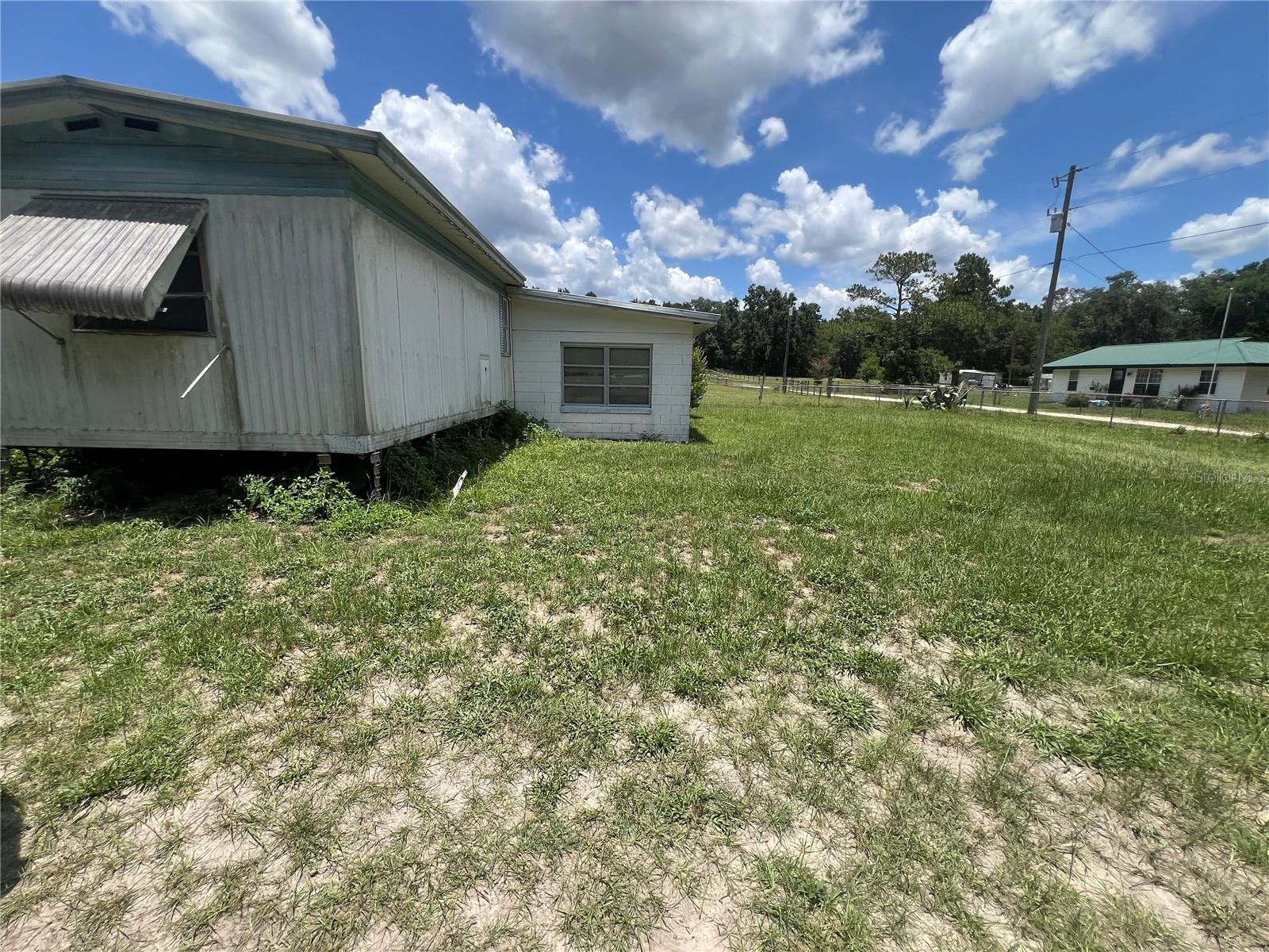 Charming Mobile Home – No HOA!--Affordable Florida Living on Private, Fenced Half Acre –
Welcome to 4636 S Lovering Pt, Inverness, FL, where peaceful country living meets unbeatable value. Priced at just $99,000, this 2 bedroom, 2 bath mobile home offers comfort, space, and privacy on a little over half an acre of fully fenced land – and it's NOT in a mobile home park! This home features a huge sunroom, perfect as a grand master suite or bonus living area, plus a solid block garage with space for a small car and includes the washer and dryer. The newer AC system is built for larger units, offering strong, efficient cooling throughout the home and sunroom. Enjoy no HOA, no pet restrictions, and the freedom to live how you want. Located in a quiet, friendly neighborhood with great neighbors, this property is a rare find for those seeking space and privacy without breaking the bank. Needs a little love, but the potential is incredible!