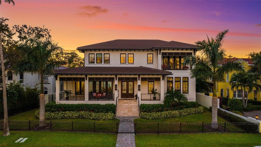 Exquisite West Indies-inspired custom home with wrap-around porches ideal for taking in the incredible water views of Tampa Bay. Situated on Coffee Pot Bayou, This very special residence allows for both protected waterfront as well as open and direct access to Tampa Bay and The Gulf of Mexico. With unparalleled luxury and craftsmanship, this residence epitomizes waterfront living at its finest. Enjoy watching the sunrise with a cup of coffee on either the front porch or the primary bedroom balcony while experiencing the bliss of the year round bay breeze. Boasting over six thousand square feet of living space, this meticulously designed residence features 5 bedrooms and 5 1/2 bathrooms. All first floor living spaces offer incredible water views, and the elevation extends phenomenal insurance savings and peace of mind. Gracious living rooms seamlessly flow from one to the next. The modern, open concept also incorporates a designated formal dining room that exudes an element of sophistication. Windows in the dining and living rooms allow for a chance to see dolphin and manatee play, with the iconic Coffee Pot Bridge in the background. On the main level is a chef’s dream kitchen – definitely the heart of the home! Two of everything important: islands, sinks, ovens and microwaves - plus a 48” gas cooktop - help create the perfect space for culinary exploration and the functionality an entertainer would need. Hide the mess in the walk-in messy kitchen, with ample storage, a wine refrigerator and room for small appliances. The first level guest suite features front porch access which means your guest may never want to leave. Even the main level powder bath has a water view! The large primary suite has a functional balcony and water views from the bedroom, sitting area and bathroom. Both the front and rear of the home open to outdoor living areas. The courtyard-style pool and patio area is complete with an outdoor dining space and a fully equipped outdoor kitchen with gas grill, ice machine, beverage cooler, and sink. The pool and spa provide a tranquil setting for relaxation and entertainment. Further enhancing the allure of this residence are the two oversized two-car garages (four car garage total), in addition to a large parking apron. The detached two car garage features a fully air-conditioned space with car lift, providing ample storage and convenience for hobbyists. Situated on the most coveted street in the city, this home offers enviable, protected dockage along Coffee Pot Bayou, with two deeded water lots along the city-maintained seawall that offer, quick access to Tampa Bay and the Gulf of Mexico. Whether admiring the stunning sunrise views, hosting gatherings for friends and family, or simply basking in the tranquility of waterfront living, this oasis offers an unparalleled lifestyle opportunity in the heart of St. Petersburg. A short one mile walk (or bike/golfcart ride) along the city’s waterfront parks brings you to the best of St. Pete, Beach Drive restaurants, the St. Pete Pier, and Albert Whitted airport. Twenty-five minutes away are the bay area’s two international airports, as well as the area’s world famous white sand beaches. Come and see why so many choose to call St Petersburg home.