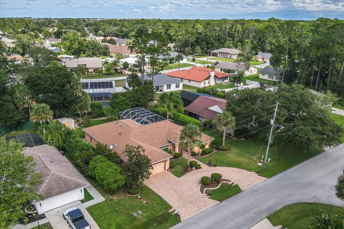Welcome to your very own slice of Florida paradise! This spectacular four-bedroom, three-bathroom saltwater pool home in highly desirable Palm Harbor checks every box. No HOA, no CDD fees—just the freedom to live the dream.
Step outside to your oversized L-shaped patio, perfectly positioned with eastern exposure to catch refreshing ocean breezes. Imagine mornings with coffee by your sparkling blue saltwater pool—solar heated in 2020 with a newer pump—or evenings entertaining with triple sliders wide open, giving the whole home a courtyard vibe. The screened enclosure was redone in 2017, so it’s all ready for you to enjoy.
Inside, the soaring ceilings and skylights flood the space with natural light. The upgraded chef’s kitchen steals the show with granite countertops, a double oven, and an infinity window overlooking the pool. It flows seamlessly into the family room, where a cozy fireplace sets the mood for those rare chilly nights.
The primary suite feels like a retreat, offering a massive walk-in closet and a spa-like bath with dual vanities, a separate shower, and a jetted tub. Need space for guests, in-laws, or teens? You’ll love the second en suite bedroom with its own private bath—perfect for multi-generational living. Plus, a convenient pool bath keeps the fun outdoors.
Every detail has been thought of: plantation shutters, a paver circular driveway big enough for all your toys, backyard storage, water softener, and irrigation well. All this, just 10 minutes to Flagler Beach, minutes from European Village, and steps to walking and biking trails.
This is more than a house—it’s the lifestyle you’ve been waiting for!