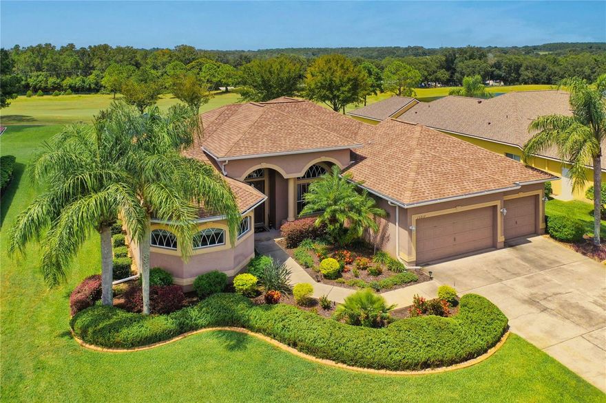 Experience SPECTACULAR SUNSETS & Golf Course Living from this Exquisite, one-owner, CUSTOM built Lexington home! Perfectly positioned on the 15th hole of the North Course of Lake Jovita Golf & Country Club, on a pristine .36 acre lot with a tranquil pond view,
in the rolling hills of East Pasco, ideally located between the new 15-acre Mirada Lagoon and historic Dade City!  From the moment you arrive, the beautifully landscaped entry and double doors welcome you into a grand interior featuring high ceilings, ceramic tile floors and expansive living spaces designed for both ease in entertaining. Triple pocket sliding glass doors open to a solar-heated pool and covered lanai, creating a seamless transition between indoor and outdoor living while enjoying the lush golf course views!  The formal dining room, accented with custom window treatments and designer touches, provides the perfect setting for hosting gatherings. The gourmet kitchen is a chef’s delight... complete with 42” cherry wood cabinetry with crown molding, granite countertops, a high bar, and a breakfast nook overlooking the pool.  The open-concept great room is the heart of the home, highlighted by an impressive arched picture window that captures panoramic views of the course.  This thoughtful three-way split bedroom plan ensures privacy for all. The owner’s retreat offers a cozy sitting area, elegant décor, and a spa-like ensuite bath featuring dual vanities, two walk-in closets, a  luxurious soaking tub beneath a stained-glass window, and a stunning walk-through shower that invites natural light through its bay-shaped transom windows. The additional bedrooms are on a seperate wing, ideal for guest rooms, home offices, or hobby spaces, with a convenient full bath in between!  Dont miss the PRiVATE SUITE at the rear of the home with its own wing, full bath and separate entrance providing direct outdoor access.  Practical touches abound, including an interior laundry room with a utility sink and shelving, and a three-car garage featuring epoxy-finished floors, custom cabinets and a workstation. This meticulously maintained home boasts numerous updates: a new 2024 five-ton AC unit, 2018 architectural shingle roof, newer 2023 water heaters, new smooth top range and dishwasher, ensuring true move-in readiness. Located within Lake Jovita’s secure, guard-gated community, residents enjoy private streets to drive golf carts on, no CDD fees and low quarterly HOA dues. Amenities include a scenic walking trail with exercise stations, basketball and pickleball/tennis courts, playgrounds, parks, and two dog parks. Optional club memberships provide access to an active social calendar, two championship golf courses, Har-Tru tennis courts, a fitness center, Jr. Olympic-sized pool, and on-site dining and events at the clubhouse, restaurant and pub.  Located just North of Tampa, with easy access to major highways to Wesley Chapel, Ocala, Lakeland, Orlando, Tampa, Airports or the Beaches, this well-maintained, remarkable home offers an exceptional opportunity to enjoy resort style living in one of Florida's premier Golf Communities of Lake Jovita... CALL TODAY!
