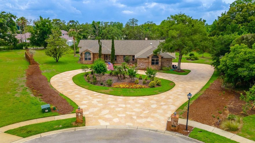 This well-thought-out custom home is situated on a beautiful lot with over 1.25 acres in the Whispering Winds neighborhood. As you enter the home you are greeted with loads of natural light in the entryway complete with a coat closet. The living room is right off the entryway and looks out the sparkling screened-in pool and covered patio and has 2 skylights. The large dining room leads in to the kitchen which provides a closet pantry with pull out drawers, granite counter tops, breakfast bar, built-in desk and eat-in area. The pool and patio area can be accessed directly from the eat-in area of the kitchen. Directly off the kitchen is the ample-sized family room featuring a gorgeous tongue and groove ceiling with 2 skylights. The family room includes a wood burning fireplace and French doors leading out to the backyard oasis. The large primary retreat features French doors leading to the patio and pool, walk-in closet, soaking tub, separate shower and two vanity areas. On the same side as the primary bedroom is another bedroom with its own hallway bathroom. On the other side of the home are 2 additional bedrooms which share a hallway bathroom that also provides access to the pool. The 3rd bedroom provides a built-in desk and beautiful wooden bookcases. The 4th bedroom includes a walk-in closet with a closet system and a window seat with storage. The 3-car garage has loads of storage and workbench space. The sparkling enclosed pool has plenty of room to for Florida sun fun. The covered pavered patio is raised from the pool deck and provides the perfect spot to enjoy a meal or visit with family and friends. Beyond the pool is ample green space. This custom home has been well cared for and has easy access to many shops and restaurants via the Markham Woods corridor. This home comes with 2 HVAC systems and a transferrable termite bond. Welcome home!