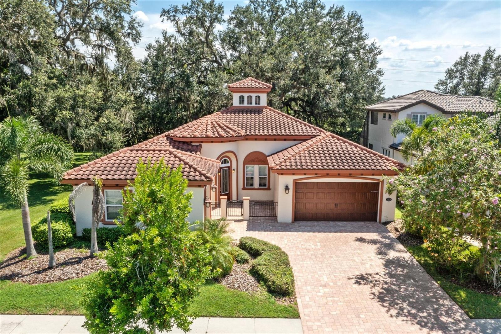 CUSTOM BUILT ONE STORY HOME! Located in the sought after GATED village of "The Gardens" on a quiet Culdesac lot & LOADED WITH UPGRADES! As you walk up you will notice the fully pavered driveway and large gated courtyard. 4 Bedrooms, 3 Full baths, and 3 Car Garage. Plus, there is a HUGE Covered Lanai with a canopy of big, beautiful shade trees! Dream Kitchen with stainless appliances: Microwave, Dishwasher, Cooktop, built-in oven, garbage disposal, Refrigerator, Subway Tile Backsplash, Granite Countertops, large flat Center Island, abundant cabinetry, & Large walk-in custom Pantry. Kitchen with eat-in nook is open to Great Room w/ surround sound and soaring ceilings with double trays & heavy crown molding. Owners Retreat & Ensuite Spa Bath including dual sinks, Garden tub & walk-in shower w/dual shower heads, Huge Closet with built-ins. Upgraded Lighting & Tile. Relax in this beautiful home that has it all! Neighborhood features: Resort Style Zero Entry Pool & Splash Zone, 6 Ln Jr Olympic Pool, & pool by Pavilion. Fitness Center, Club House, Tennis & Basketball Courts, Large & Small Dog Park, Splash Court, 2 Large Parks with playground plus, Private Sports Courts with Playground & basketball Court in each village. Excellent location with a new Publix, Chick-fil-A, Florida Medical Clinic, a new Daycare, Starbucks, Circle K, nail shop, dental office, veterinarian, and much more coming just outside the entrance to the neighborhood. Close to Great Schools, Community College, Hospitals, Wire Grass Mall, Tampa Premium Outlet Mall, Ice Rink, Sams Club, Costco, Movie Theater, and lots of Dining. Easy access to I75, 275, Tampa Interational Airport and Downtown Tampa. CDD is already included in tax amount.