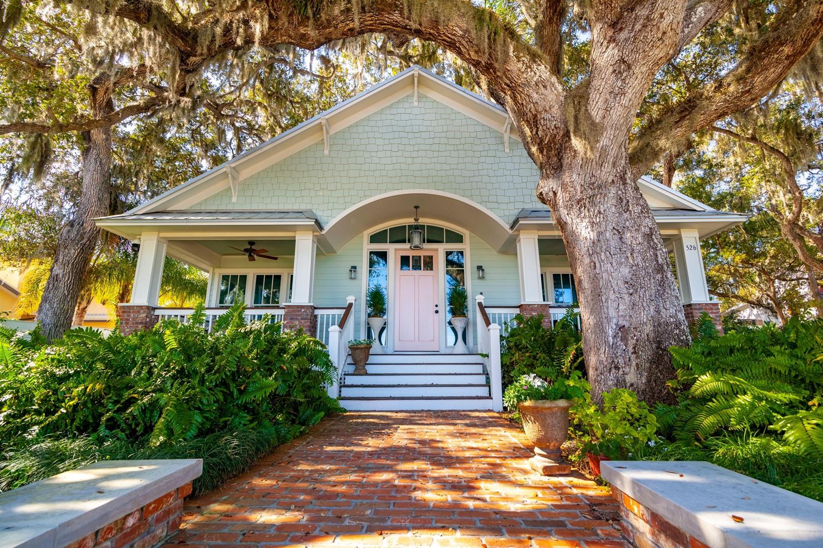 Waterfront estate situated on almost an acre in the heart of town. With 6 bedrooms, 5 full & 2 half baths in all, the main home has gorgeous reclaimed wood floors & Carrera marble kitchen & baths throughout. Cathedral ceilings & lots of windows provide abundant natural light filtered through the historic Oaks. Amazing kitchen with SubZero refrigerator & commercial Wolf range. Family room with cathedral ceilings has 3 sets of French doors opening to lovely screened porch that overlooks the lush, shady yard. First floor master suite with 2 sinks & water closets & 2 sided glass shower. Second level features another family room, 3 bedrooms & 2.5 baths, plus separate suite above garage offering space for private office or guests. The detached guest cottage has wood floors, large open great room with kitchen, bedroom & bath. Boat house with dual slips & lifts plus floating dock. Reclaimed water for irrigation. Natural gas for ranges, 3 water heaters (2 are tankless). Both house & guest house have washer/dryer. Cottage HVAC installed 2020, other HVAC’s during 2014/2015 renovation. This one-of-a-kind property has ample room for those who wish to add collector’s garage, custom workshop space & more. ;Water: City