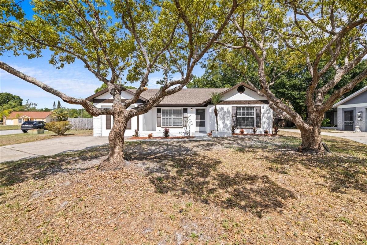 One or more photo(s) has been virtually staged. Immaculately remodeled 3 bed 2 bath home located on a cul de sac street for added privacy in the heart of Oldsmar, FL. Step foot into this modern home greeted by beautiful vaulted ceiliings leading into the new quartz kitchen featuring a peninsula design with wood shaker cabinets, quartz countertops, tile backsplash and stainless steel appliances. New luxury vinyl plank flooring with updated baseboards throughout, new light fixtures, ceiling fans and a newer 2023 HVAC unit. Spacious primary bedroom, ensuite bathroom feauturing a split bedroom layout, indoor laundry with modern stackable washer and dryer included. Rear screen porch and a brick pavered back yard surrounded by a wood privacy fence. This home sits in a convenient location steps from Sheffield Park that features many amenities such as a hiking/running trail, tennis and basketball courts, playground and covered pavillion for events. Quick drive to new shopping centers, restaurants, downtown Tampa, international airport, clearwater beaches and St Pete! Turnkey home with NO HOA, NO hurricane damage and NO flood history. Easy to show, book your showing today!