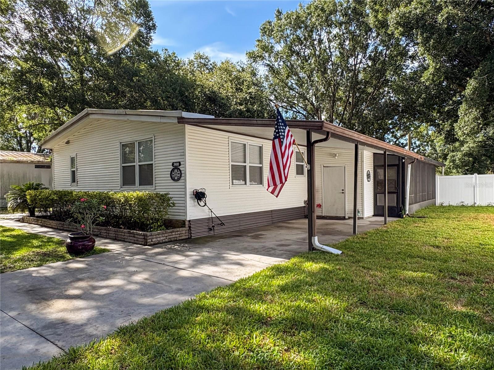 This well-maintained 1985 double-wide manufactured home sits on a spacious 0.23-acre lot and offers great value and comfort. Step inside to a cozy living room with a gas fireplace and easy-care laminate flooring throughout.
The home features a bright, partially furnished family room with large windows that let in plenty of Florida sunshine. The kitchen comes fully equipped with appliances and a separate dinette area perfect for casual dining.
The primary bedroom includes an en-suite bathroom, while the two additional bedrooms share a second full bath. A dedicated laundry room includes a washer and dryer for added convenience.
Enjoy relaxing evenings on the screened lanai overlooking the backyard. Outside, you'll find both a workshop and a separate storage shed for all your tools and extras.
Don't miss this opportunity. All sizes and information believed to be accurate but should be verified by buyer and / or buyer's agent.
