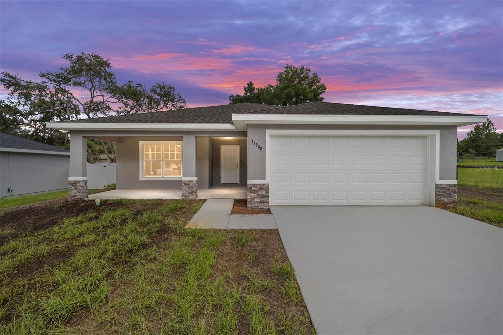 One or more photo(s) has been virtually staged. New Construction Home in Orange Blossom Hills – Next to The Villages!
Welcome to Orange Blossom Hills, a quiet and scenic neighborhood perfectly located just feet from The Villages, one of Florida’s most sought-after communities. Enjoy all the nearby shopping, dining, golf, and entertainment options without the HOA fees or age restrictions!
This beautifully built home offers nearly 1,800 sq ft of living space with an open and functional layout you’ll love. Features include: Granite countertops throughout, Oversized walk-in pantry, Huge master closet, Stylish master bathroom design, Spacious front and back porches – perfect for relaxing or entertaining. Enjoy the best of both worlds – a peaceful country setting with instant access to the vibrant lifestyle of The Villages. Don’t miss this opportunity – schedule your tour today!