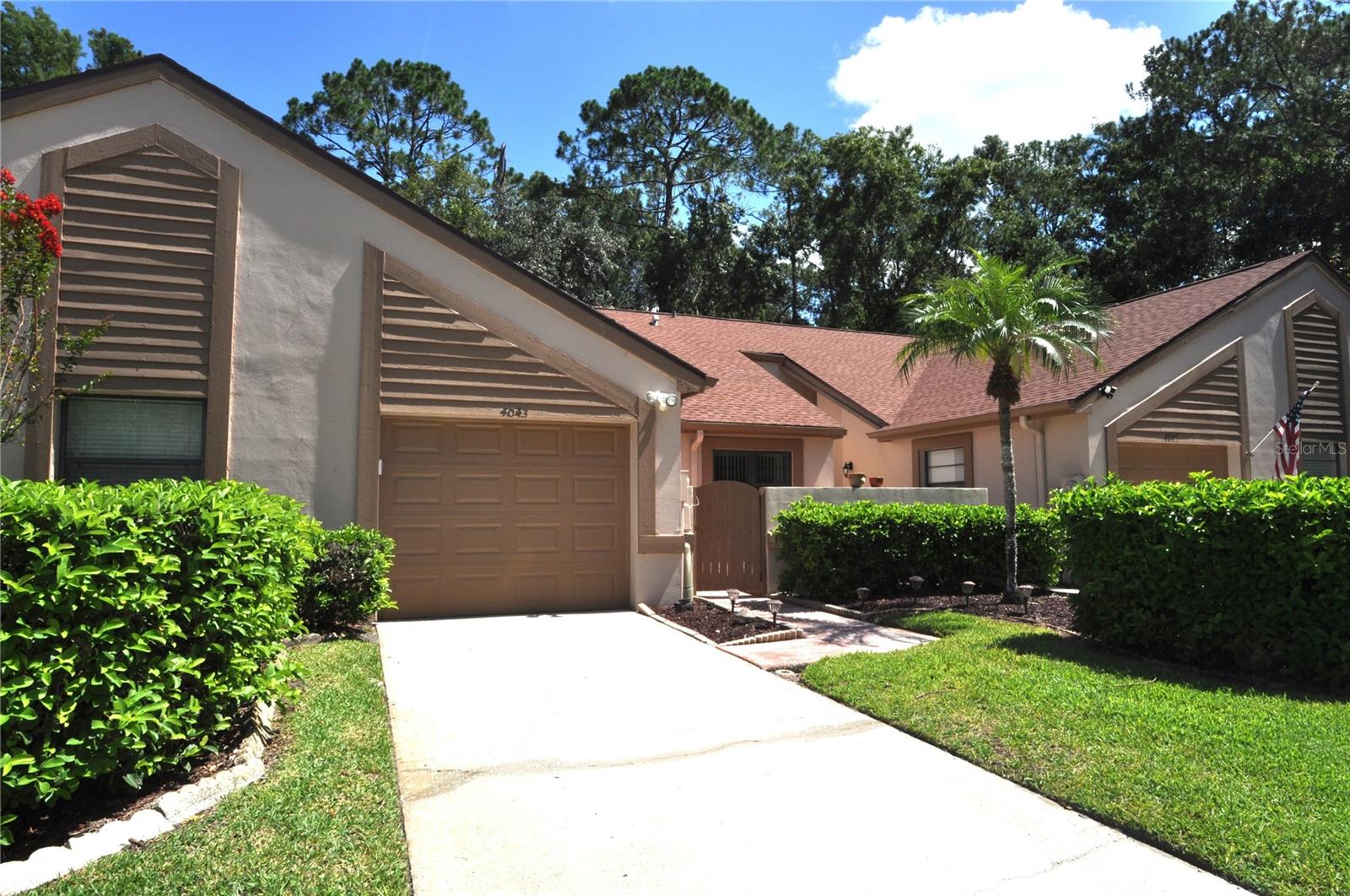 Welcome to this inviting 2 bedroom, 2 bath villa with a 1-car garage, perfectly nestled along the scenic Brooker Creek Preserve in the desirable Brookhaven community of Ridgemoor. This well-maintained home offers a tranquil lifestyle with peaceful nature views right from your expansive screened-in deck—an ideal spot for morning coffee or evening relaxation. A beautifully designed front courtyard creates a grand and graceful first impression, offering a serene, sunlit space ideal for lounging, dining al fresco, or enjoying the soft sounds of nature.
Step inside to find vaulted ceilings that enhances the spacious living area, complete with a cozy wood burning fireplace. The eat-in kitchen provides a functional layout and a charming space to enjoy casual meals. The formal dining area is just beyond the open pass-through. The split bedroom floor plan ensures privacy, and the primary suite features a walk-in closet, an en-suite bath and an office space with extra storage.
Enjoy the convenience of inside laundry with washer and dryer included and plumbing if the buyer wants to install a laundry tub, along with newer windows for added efficiency. Residents of Brookhaven also enjoy access to a sparkling community pool and the natural beauty of the preserve.
Located in a maintenance-free community, you’ll enjoy the benefits of carefree living in the desirable Brookhaven neighborhood, complete with proximity to East Lake’s top-rated schools, shopping, and dining. Brookhaven is a gated community, offering a prime location for outdoor activities including the Pinellas Trail and a short distance to John Chesnut Park with boat launch for access to Lake Tarpon. Ridgemoor Master association has a playground, basketball and tennis courts and plenty of sidewalks for your open-air enjoyment.
Don’t miss your chance to own a slice of Florida paradise with unbeatable preserve views and low-maintenance living!