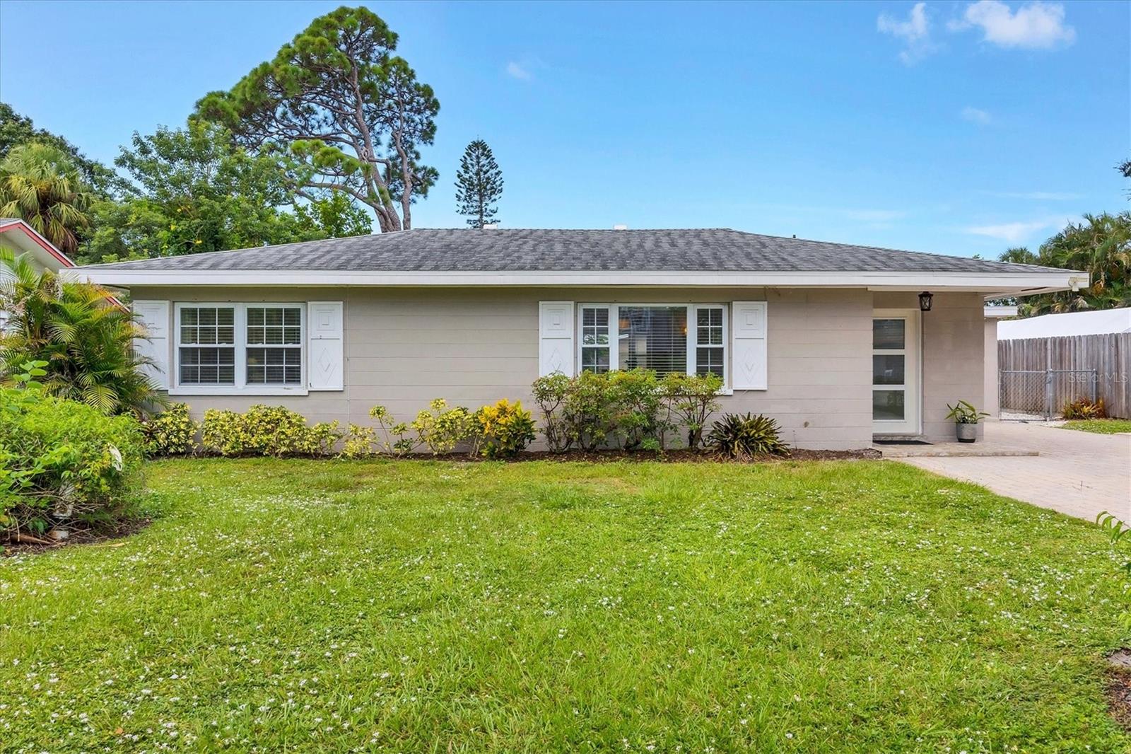Welcome to this Mid-Century gem in the heart of Sarasota. This beautifully remodeled 3-bedroom, 2-bathroom home is situated on a spacious quarter-acre lot. Whether you're looking for a personal residence, seasonal getaway, or rental opportunity, this fully fenced property offers flexibility and functionality in a prime Sarasota location. As you enter you will be greeted by an abundance of natural light and luxury vinyl plank flooring throughout. The spacious living room flows into a formal dining area and a large open kitchen with newer appliances, wood cabinets and granite counter tops. A separate den provides additional space for a home office or cozy retreat overlooking your large, private backyard. Two bedrooms and a full bath sit on one side of the home, while the opposite side features a private suite with its own entrance, bathroom, and AC - ideal as a primary bedroom, mother-in-law suite, or income-producing rental. Upgrades include newer windows, a new roof in 2018, city water (a rare bonus in this neighborhood), and renovated bathrooms. This home is located in a highly desirable school district, is a few houses away from a walking or biking path to the Southgate mall area, and is in close proximity to downtown Sarasota, shopping, restaurants and the azure beaches of Siesta Key.