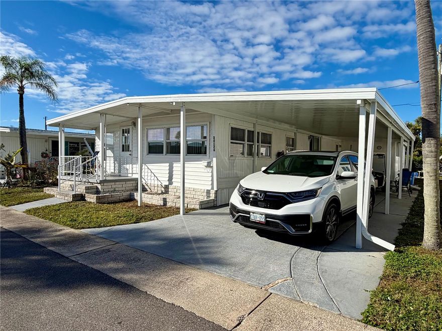 YES this price DOES include the Share valued at $55,000… 2 beds, 1 bath home with a new (12/24) oversized carport, good size living space, updated bathroom, lots of extra storage space in home and an eat in kitchen. The Front windows have recently been replaced and are double pane. 2nd bedroom closet was turned into an inside laundry with some hanging space and storage as well. All windows in the home have blinds. Roof was replaced approx 5 yrs ago. MUST SEE, this home is priced to SELL QUICKLY! Golf cart can be sold separately. Very affordable park, monthly HOA is ONLY $210 per month which includes WATER, SEWER, and TRASH, owned clubhouse, escrows are fully funded, beautiful heated pool and spa, fitness center, library, shuffleboard, billiard table, grounds maintenance, and a small lake at the back of the park, laundry room, and your very own private entrance to the SUPER WALMART… on foot, bicycle or golf cart… Etc., etc. Sunset Palms is in close proximity to the beaches, airports, I – 275, churches, restaurants, all kinds of shopping, etc.… Seller is leaving a golf cart for the next owner (needs a battery), other than that, it works.