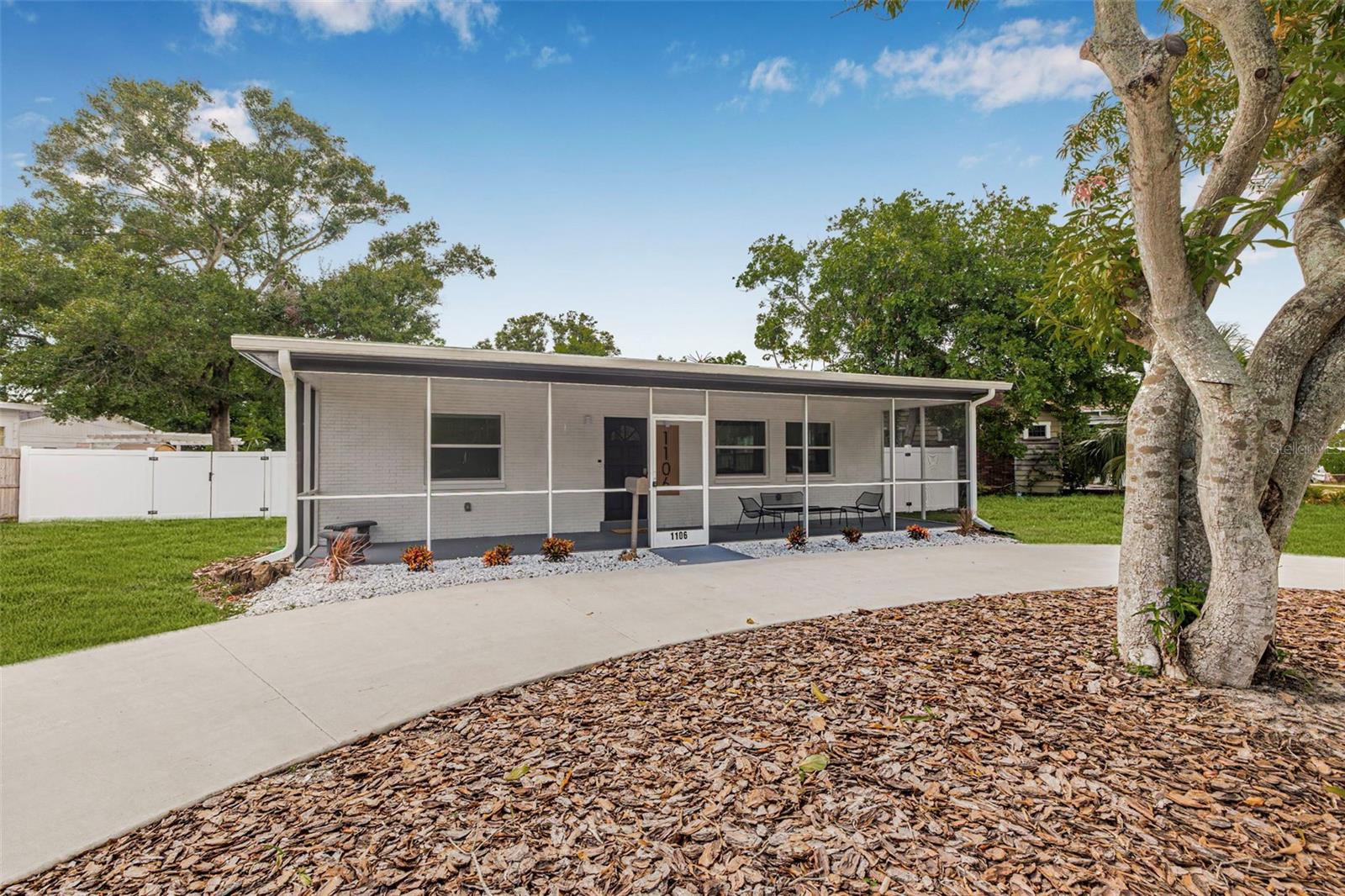 Welcome to 1106 29th St N, a meticulously redesigned 3 bedroom, 2 bathroom non flood zone block home on a HUGE lot in the heart of North Kenwood—offering a rare combination of timeless craftsmanship, modern luxury, and expansive outdoor space. This residence has been completely remodeled from top to bottom, showcasing custom millwork, soft-close two-tone shaker cabinetry with under-cabinet lighting, quartz countertops, and a premium stainless steel appliance package. Natural light pours in through the updated windows and fills the open concept layout with natural light, enhanced by recessed LED lighting, brand new window treatments, and LVP flooring throughout. Both bathrooms have been beautifully reimagined with upscale finishes, adding to the cohesive elegance of the home. A brand new roof, gutters, HVAC, fencing, and sewer line ensure worry-free living for years to come. The brand new washer and dryer are conveniently included in the dedicated laundry space. Step outside to enjoy the peace and privacy of your screened-in porch, perfect for relaxing or entertaining. The wrap-around driveway offers exceptional parking and curb appeal, while the expansive lot provides endless potential for a pool, guest house, or garden retreat. Call today for a private showing!