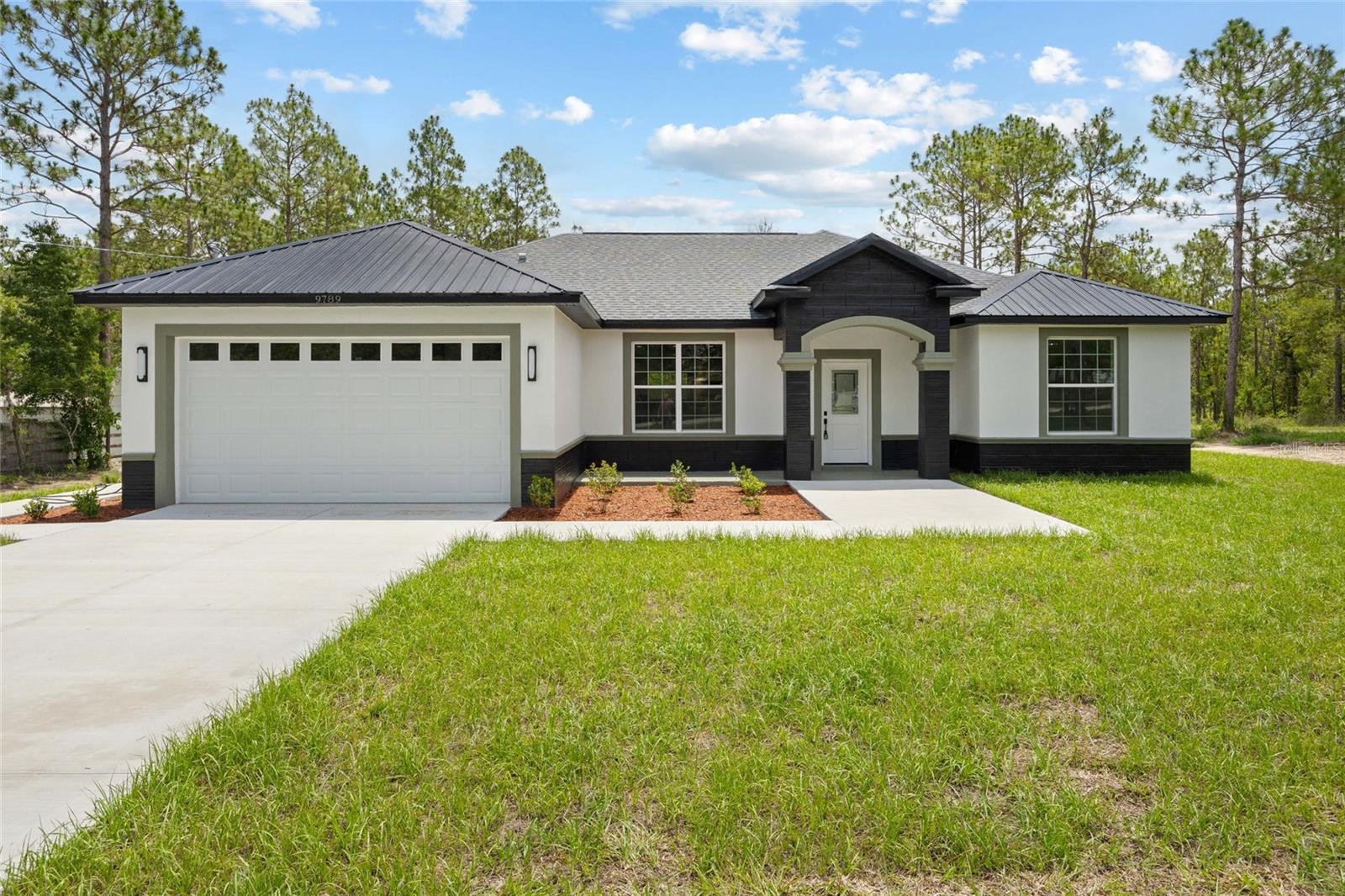 Welcome to this stunning 4-bedroom, 3-bathroom home nestled in a quiet corner of Dunnellon. Boasting over 2,700 total square feet with 2,011 sq ft of living space, this spacious residence offers both comfort and style. Step inside to find high-end fixtures and elegant finishes throughout, from the custom lighting to the tasteful architectural details. The split floor plan provides privacy and functionality, perfect for families or hosting guests. Enjoy a spacious kitchen with ample counter space, a cozy living area, and a generous master suite with a luxurious en-suite bath. With a 2-car garage, indoor laundry, and located just a short drive from shopping, dining, and the Rainbow River, this home truly has it all. Don’t miss your chance to own this beautiful property schedule your private tour today!
