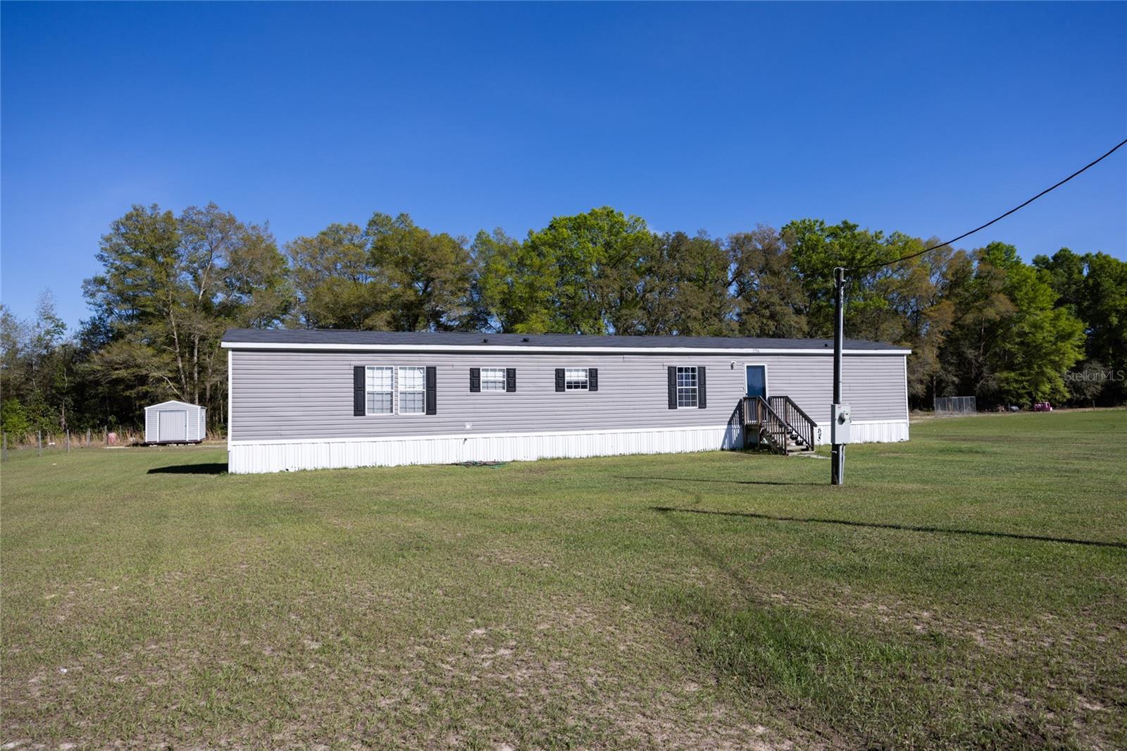 Under contract-accepting backup offers. *VALUE ALERT! Priced below recent appraisal* Looking for your very own private sanctuary of comfort and luxury? Meticulously cared for, this stunning 3 bed/2 bath single-owner home was built in 2018 and sits on over an acre of land. You’re guaranteed to enjoy the safety & maintenance free living that only a well-kept home can offer. Step inside and marvel at the attention to detail, including crown molding, beautiful flooring and an island kitchen. The split floor plan provides ample space for everyone to spread out, and the included washer/dryer in the convenient laundry room makes daily chores a breeze. And the home has upgraded insulation to keep those energy bills down!
Take advantage of the spacious lot, complete with a shed and a fire pit, perfect for enjoying a cozy evening outdoors. This well-kept, high and dry property offers the perfect combination of location and affordability. Whether it's lower taxes, utility costs, or a day on the water you're sure to be pleased.
Located just a short drive from the bustling downtown High Springs and sharing a property line with Blue Springs State Park, this property checks all the boxes. Bring your bikes, boat or diving gear because the outdoor opportunities are unmatched with this truly special part of Florida. Don't miss out on this chance to own a beautiful home on a prime piece of real estate. Call today to schedule a private appointment!