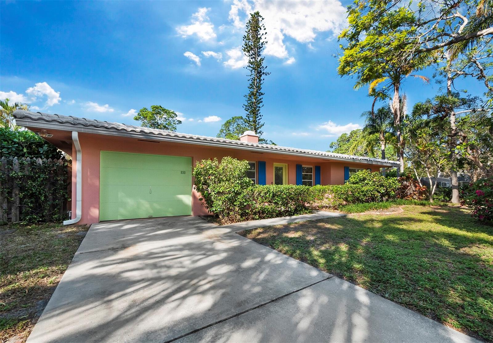 This highly desirable Hudson Bayou neighborhood offers a unique opportunity to create your dream home or to occupy as-is. The incredibly valuable parcel, the third lot in from Hudson Bayou on a peaceful dead-end street, is ideally situated in an X zone with an incredible sense of privacy and nearby access to a kayak launch at the end of Pomelo Avenue. A flourishing landscape of established tropical plants creates an oasis for the home site, while the property enjoys close proximity not only to Sarasota Bay but to the amenities of West of Trail and Downtown Sarasota. Across the street, Pomelo Park adds to the location’s quietude and the verdant abundance of this sought-after enclave. Luxury new-build homes surround this large parcel, enhancing the appeal of designing a private estate here, just a short distance from the bayfront, Selby Gardens, Southside Elementary School, Sarasota Memorial Hospital and more.
The petite home, notably crafted by builder Ruth Richmond in 1966, is move-in ready, with an enclosed lanai, restored terrazzo floors, quartz countertops and a one-car garage.