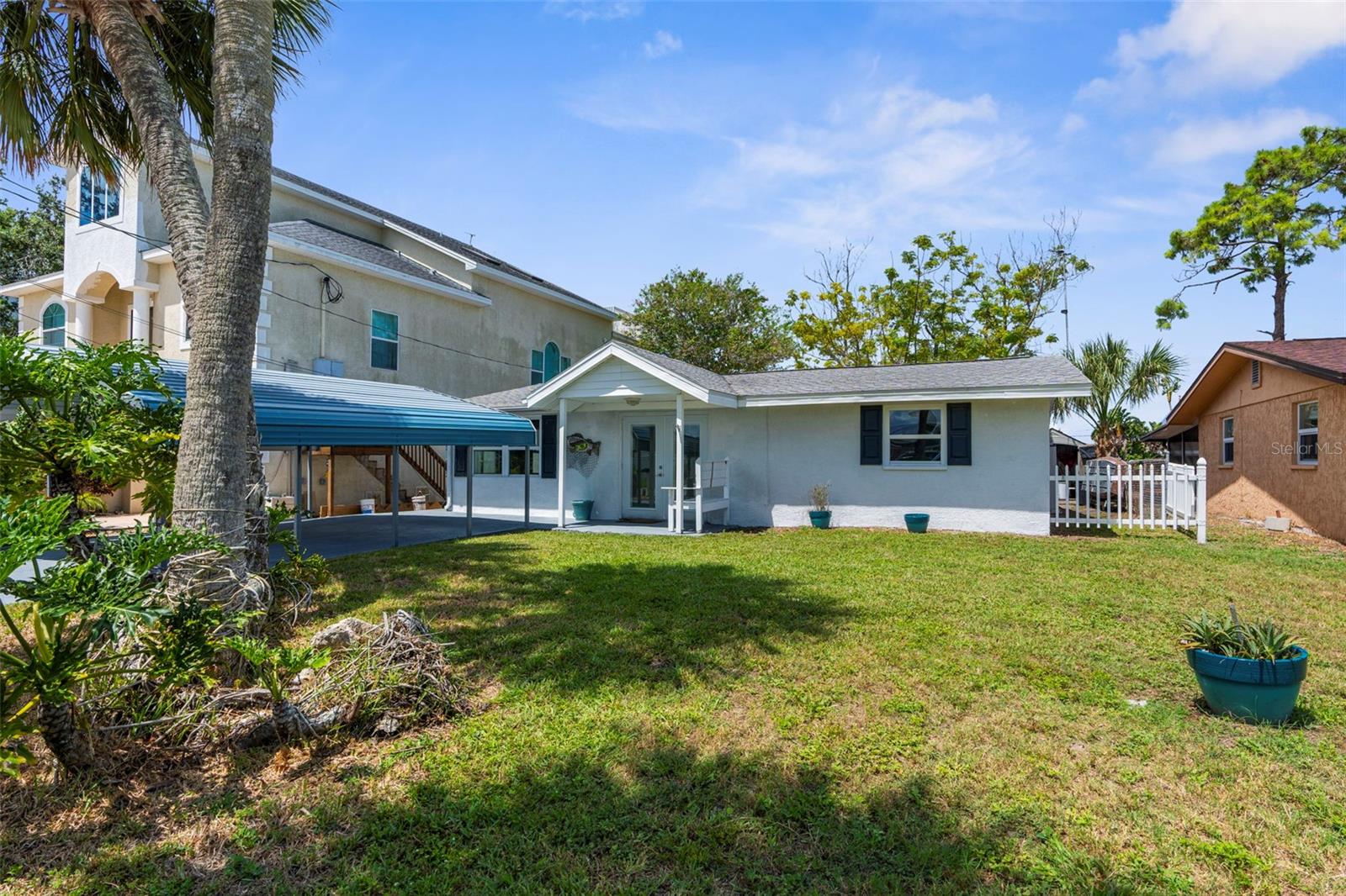 Welcome Home to this stunning 3 bedroom 2 bathroom completely renovated waterfront home with dock & lift that is literally seconds down the channel right to the Gulf! Enter from your covered parking, right under the front porch to an essentially brand new home with new luxury vinyl flooring, brand new kitchen & bathrooms and so much more! Open floor plan with a living room up front and a bonus room/dining room in the back that overlooks your huge covered back porch along the water! Garage conversion is already done, so you don't have to! Can be a 3rd bedroom or office or air conditioned storage etc and then ample storage in sheds out back so bring all your toys, supplies and anything that makes this house your HOME with plenty of space to soak in all the best of that enviable Florida Lifestyle! This one is truly a must-see! Schedule your showing today!