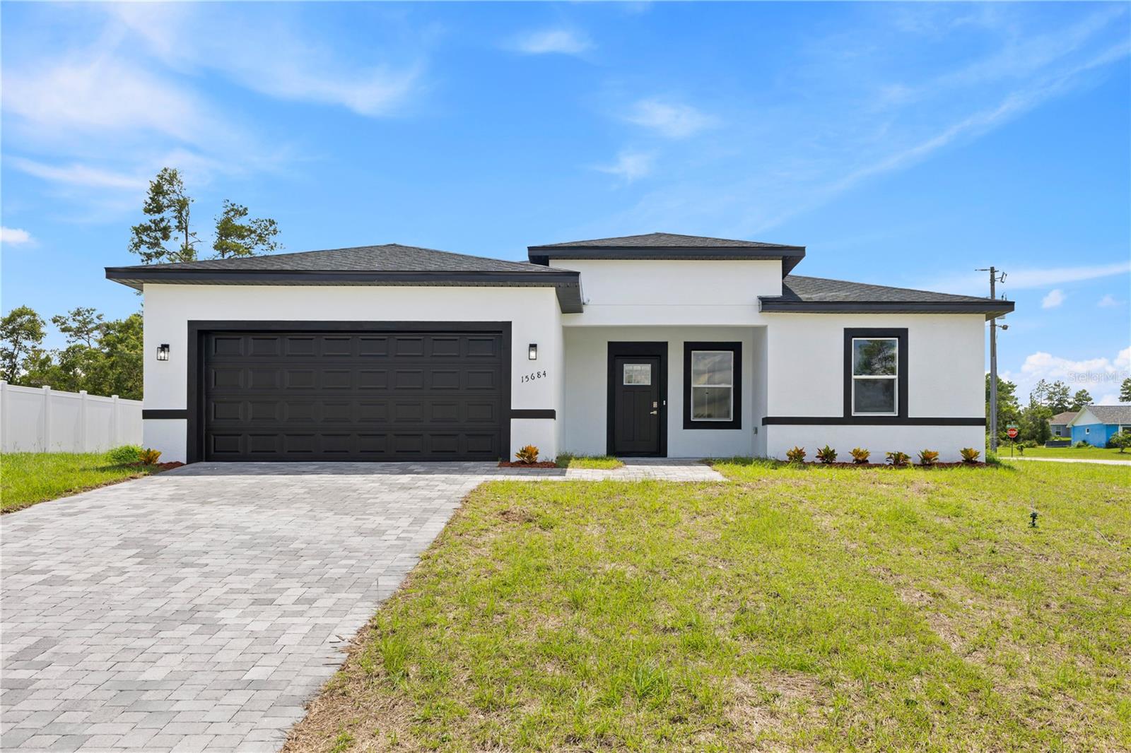 This brand-new home is filled with upgrades and offers a perfect blend of style, comfort, and functionality. Featuring 1865 sqft of heated living area and situated on a large corner lot for added privacy and outdoor space, this modern single-family residence includes 4 bedrooms, 3 full bathrooms, and a 2-car garage with a smart, open-concept layout.
The main living area flows into a designer kitchen with a center island featuring custom wood slats and waterfall countertops on both sides, an elegant backsplash, and sleek modern cabinetry. Wood slat accents also elevate the aesthetic in the living room, master bathroom, and entryway, adding a unique and contemporary design touch.
The spacious primary suite includes two separate walk-in closets and a beautifully appointed private bathroom. Every corner of this home has been thoughtfully crafted to combine design and functionality.
Located in the fast-growing Marion Oaks community, with easy access to schools, shopping, and main roads. Move-in ready — schedule your showing today!