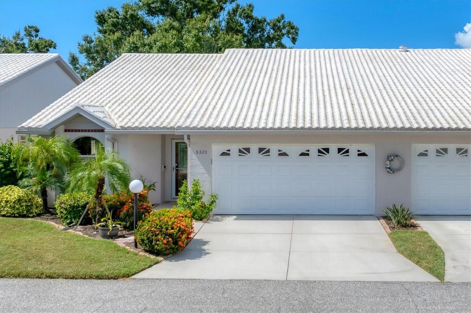 Step inside this beautifully maintained and thoughtfully updated 3-bedroom, 2-bath residence, offering 1,938 square feet of spacious, light-filled living. From the moment you cross the threshold, the world fades away, and you're welcomed into a haven of calm—where comfort and elegance meet in perfect harmony. Color-drenched walls and rich, upgraded light fixtures complement an elegant, timeless color palette, while soaring cathedral ceilings and plantation shutters enhance the home’s sense of scale and refinement. The flexible floor plan includes a formal living room, family room, and dining area, giving you endless options to tailor the space to your lifestyle. One of the bedrooms is currently being used as a stylish home office, ideal for remote work or quiet reflection.
The kitchen is a true culinary delight, offering abundant cabinetry and counter space, stainless steel appliances, and a bar-height counter perfect for casual dining or entertaining. Just off the kitchen, the garage boasts a utility sink, gleaming epoxy floors, and an additional refrigerator that conveys with the home.
Your serene primary suite offers two generous walk-in closets and an ensuite bath with a luxurious soaking tub—the perfect place to unwind at the end of the day. Thoughtfully positioned, the two secondary bedrooms ensure privacy for the primary suite, making this home feel even more spacious and well-planned.
Step outside to a screened-in patio that serves as a delightful escape—an outdoor living area finished with classic pavers, framed by a private stucco wall, and brimming with charm. Whether dining alfresco, enjoying a quiet morning coffee, or soaking in the included hot tub, this serene retreat offers shade, privacy, and ample headroom for umbrellas—making it your go-to sanctuary year-round.
Located in a vibrant, amenity-rich community, residents enjoy access to a recently renovated geothermal heated pool (2024), new roofs on the villas and an active clubhouse with year-round events and games like Mahjongg, Bridge, and Poker, as well as tennis and pickleball courts.
Ideally positioned near shopping, dining, A-rated schools, hospitals, and I-75—plus just a short drive to Siesta Key, America’s #1 Beach—this home offers the perfect balance of peaceful living and everyday convenience.