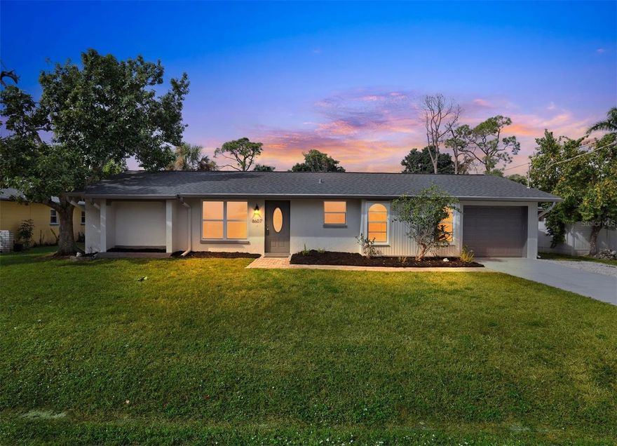 One or more photo(s) has been virtually staged. This charming Fort Myers home is perfectly updated down to the smallest detail. A newly sealed driveway and a tidy paver walkway leads you home. Head inside to an open concept floor plan with wood tiled floor throughout. A spacious living room leads to a sunny dining room overlooking the screen patio and fenced backyard. An updated galley kitchen features abundant cherry cabinetry with granite counter tops giving you several prep areas and exceptional storage for all your cooking and baking needs. A stylish tile backsplash and upgraded stainless appliances including a flat top stove and wine fridge make this kitchen the heart of the home. A split floor plan gives both bedrooms plenty of privacy. The owners suite features a well appointed walk-in closet and full en-suite bath with dual sinks and built-in shelving. There is a 2nd full bath and additional bedroom with a spacious closet and exceptional natural light. White trim and neutral paint are the perfect canvas for your decorating ideas and natural light brings this property to life. Welcome Home!