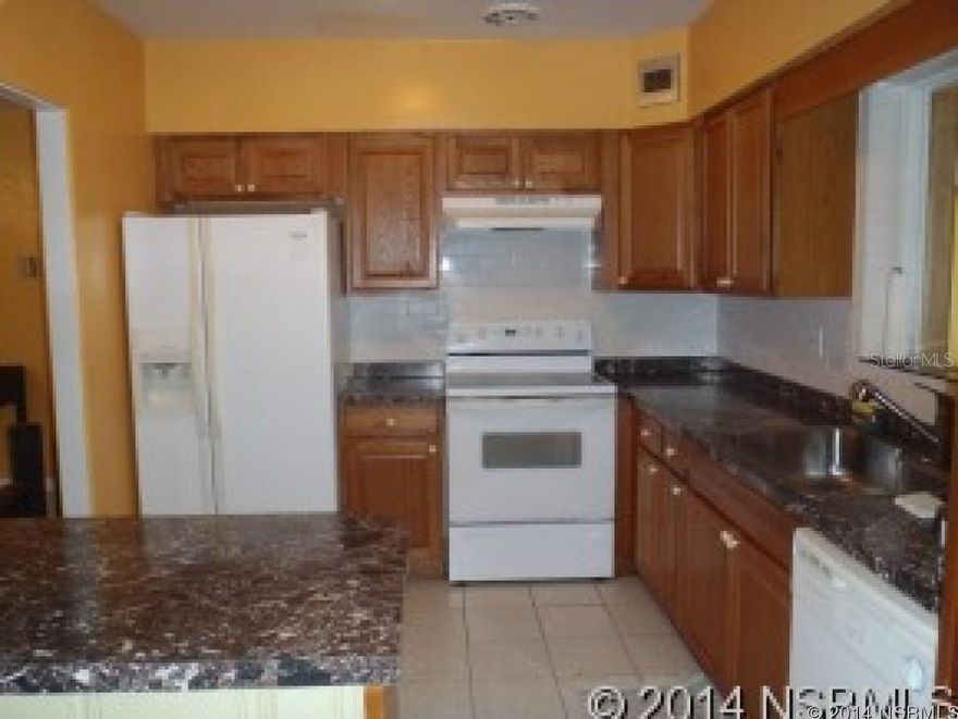 Nicely updated block home with peaceful view of tropically landscaped pond in the backyard. Quiet neighborhood close to restaurants, schools, shopping and short ride to the beach. Updated Kitchen has breakfast bar, wood cabinets & white appliances; a/c & gas water heater new 2013, electrical updates & interior painted 2013. Fabulous wood deck built in 2013 overlooks pond & fenced yard with attractive picket fence. Also features large family room with beaded wood walls & lots of windows for natural light. Carport, 12x21, has attic & additional shed, 12x8.5 in the back for plenty of storage