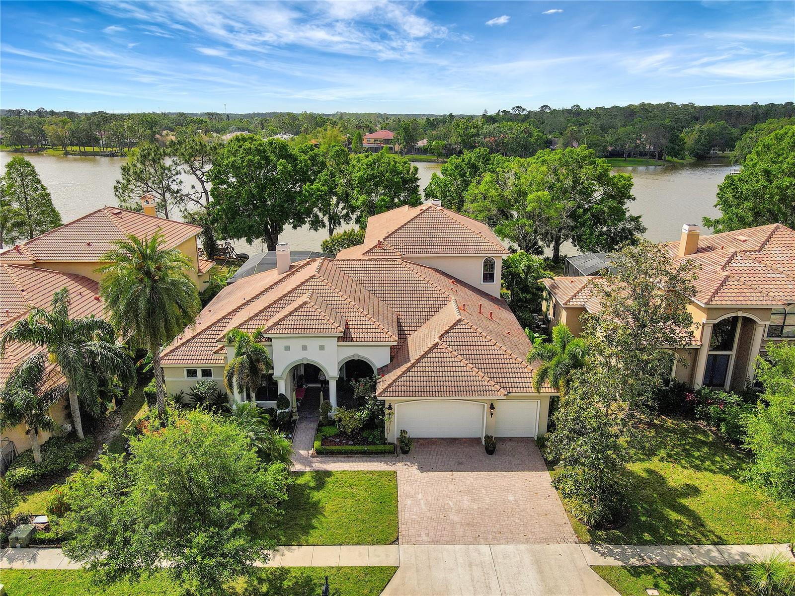 Under contract-accepting backup offers. WELCOME HOME to the Exclusive Gated Community of Tree Tops Lake, nestled in the heart of Westchase. This stunning custom-built home offers 5,000 sq.ft. of LUXURY with EXPANSIVE LAKE VIEWS and 2,100 sq.ft. of RESORT STYLE OUTDOOR LIVING, making it an unparalleled oasis, perfect for gracious family living and executive entertaining.
THIS BEAUTIFUL, WELL MAINTAINED HOME OFFERS EVERYTHING YOU COULD POSSIBLY WANT AND MORE! An Open Floor Plan, with
5 BEDROOMS, PLUS HOME OFFICE, A PERFECT "4 WAY BEDROOM SPLIT DESIGN", providing ample space and privacy. From the moment you enter, you will appreciate all the UPGRADES and ATTENTION TO DETAIL through out. Two Beautiful Stone Gas Fireplaces, Crown Molding, and Custom Designer Window Treatments are just a few of the UPGRADES INCLUDED. All first floor rooms open to the GRAND LANAI, with the SPARKLING LAKE just beyond. The STUNNING CHEF'S KITCHEN is a Culinary Enthusiasts Dream!! Miles of Gorgeous Quartz, WOLF Double Ovens with Warming Drawer and 36" Wolf Gas Cook Top, SUBZERO Refrigerator, Two ASKO Dishwashers. Beautiful Wood Cabinets and a Custom Built in Banquette with Generous Seating for 10, and HUGE WALK IN PANTRY. The ELEGANT PRIMARY SUITE located on the 1st floor, is its own PRIVATE WING OF LUXURY LIVING at over 900 SQ. FT., complete with an EXQUISITE EN SUITE BATH, Jetted Tub, double entry Tile Shower and double Vanities. The SPECTACULAR WALK IN CLOSET, is Custom Cherry Wood and features a Granite Island of Dresser Drawers. A private sitting area and French Door Entrance to the Pool/Spa and Lanai. LAKE VIEWS, OF COURSE! The Large Family Room off of the Kitchen provides another private wing with 3 Bedrooms and two baths. The upstairs is a Magnificent World of its own. A FABULOUS GREAT ROOM (There is a reason it is called a GREAT ROOM, 528 Sq Ft!) with a Built in Wet Bar and a U-Line Refrigerator/Wine Chiller. In addition, the upstairs offers A Huge Screened Patio, An Additional Guest Suite and Bath, and a Handsome Private Office with Gorgeous Cherry Wood Bookshelves and Built In Partners Desk, and LAKE VIEWS, OF COURSE. THE ENORMOUS SCREEN ENCLOSED HEATED SALTWATER POOL/SPA AND LANAI provide Florida Outdoor Living at its finest, complete with an OUTDOOR KITCHEN WITH ALFRESCO GAS GRILL AND GAS FIREPLACE. So many beautiful spaces inside and outside, THE OPTIONS OF WHERE TO RELAX AND ENJOY LIFE ARE ENDLESS! Close to all that Tampa Bay Area provides, World Class Restaurants, Professional Sports, Exceptional Performing Art Venues and Art Galleries, Sugar Sand Gulf Beaches, Great Shopping, International Airports and more. This is the home you have been dreaming of. Now your dream can come true!