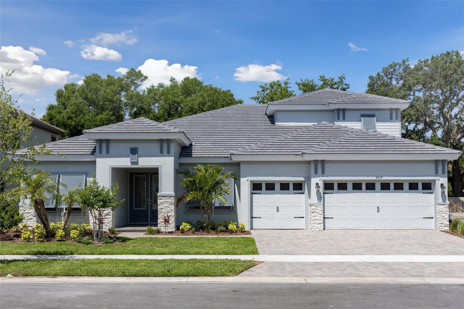 This Cedar Key II Quick Move-In home is Ready Now! This home features Sonoma Painted Linen cabinets, Telluride Daltile Quartz counter-tops, Pride Plus LVP flooring, and more. The Cedar Key II presents a bright and breezy layout that seamlessly transitions from the foyer to the expansive open living spaces! With its impressive 12-foot ceilings in key areas like the foyer, cafe, grand room with beautiful wood beams, and a fully upgraded kitchen with gourmet style appliances and an oversized walk-in pantry. The lavish downstairs owner's retreat boasts a double door entry, spacious walk-in closets, and a luxurious owner's bath that includes a freestanding tub and designer upgrades. This home also features ample secondary bedrooms, including an oversized secondary bedroom with an en-suite bath, a generously sized laundry room, and expansive outdoor living space with a covered lanai. Additionally, there's an extended bonus room on the main with French doors to the lanai, a den with French doors, and an upstairs bonus room, bedroom and bath. Welcome to Crestwood Estates, a new home community in the well established neighborhood of Valrico, FL. This community will come standard with tile roofs and paver driveways. Completion date subject to change.