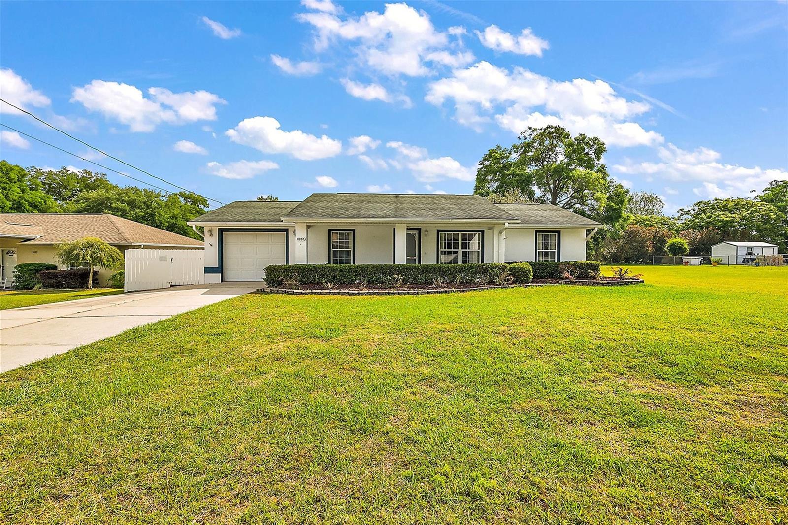 WELCOME to this NICELY MAINTAINED 3/2 home in the FAMILY- FRIENDLY NEIGHBORHOOD of LAKE WEIR GARDENS!!!BEAUTIFUL HARDWOOD/LAMINATE through the Main Living areas and Bedrooms. The Kitchen boasts SOLID SURFACE COUNTERTOPS, updated APPLIANCES, and generous amounts of WHT CABINETS with Updated HARDWARE.Just off the kitchen via a POCKET DOOR is a LAUNDRY RM-with CABINETRY!! Enjoy a spacious, carpeted lanai for relaxing or entertaining. HOT WATER HEATER 2018, Roof- 08, HVAC-08, The property also features a SHED W/ELECTRIC and a FENCED IN BACKYARD.The seller will Purchase a ONE YR BROWARD FACTORY HOME WARRANTY for the buyer. The seller is leaving a PORTABLE GENERATOR for the new owner as well. This neighborhood has NO HOA and is close to the Town of Belleview, Marion Market, Ocala and The Villages.Don't miss this one. CALL TODAY FOR YOUR PRIVATE TOUR!