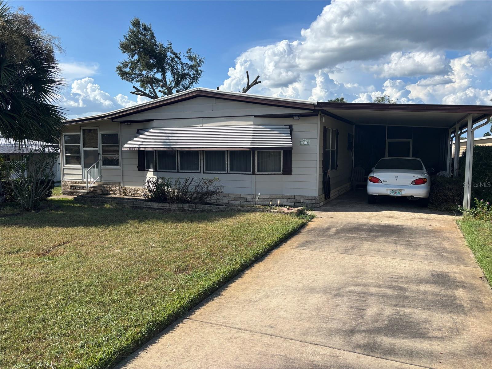 Spacious 2-bedroom, 2-bath home on a large corner lot with over 1,500 sq. ft. of living space in a desirable 55+ golf community where you own the land. This well-maintained home features generously sized rooms and plenty of natural light. Furnishings can stay, making it easy to move right in. While comfortable as-is, it offers an excellent opportunity for updating to suit your style — and is priced to sell quickly! Enjoy resort-style living with access to golf, clubhouse activities, and community amenities, all in a beautifully landscaped neighborhood.