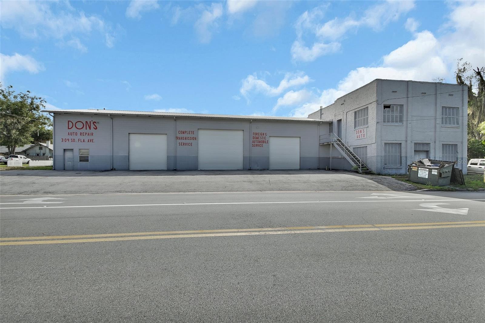 Established business since 1972 as a successful Auto Repair Shop. Fully functional and ready to go with 12,228 sq. ft of usable working space, 7 Bays and 6 Car lifts. 2 additional parcels included in this sale which include 701620010070 136 W Voorhis Ave Deland and 701620010110 141 W New St Deland. Although this property is set up for an Auto Repair shop, this property which comes with 3 individual parcels includes all types of zoning for all different types of usage. Light Manufacturing, Warehouse, Commercial, Office space and Residential. .91 acres covers all three parcels. Attached in pics you will find all the different uses for this property and land. You will find 3 different entry access areas to this property, which is great for renting out different parts of this huge building creating 3 different rental spaces. You can enter off of Voorhis as well as W New St and of course the main entrance off of Florida. The property has lots of equipment that can stay if negotiated with the building including a commercial sized compressor and 6 lifts, motor lifts etc. The main shop includes a waiting room, office, 2 bathrooms, parts room, upstairs apartment and several separate areas for storage. 3 large bays across the front of the building which are tall enough to accommodate a semi truck. Off of Voorhis Ave, you can enter the property and find plenty of parking with 4 additional bays and bathroom in the back area. On the New St side of the property you will find a vacant lot for lots of additional parking. Located just at the end of the Famous Downtown Deland area you are able to walk to all the fantastic restaurants, shops and events that Deland has to offer. This is a fantastic location for starting your new business or finding a larger building for your established business. Give me a call today for your private tour to see how you can turn this property into your money making dream!