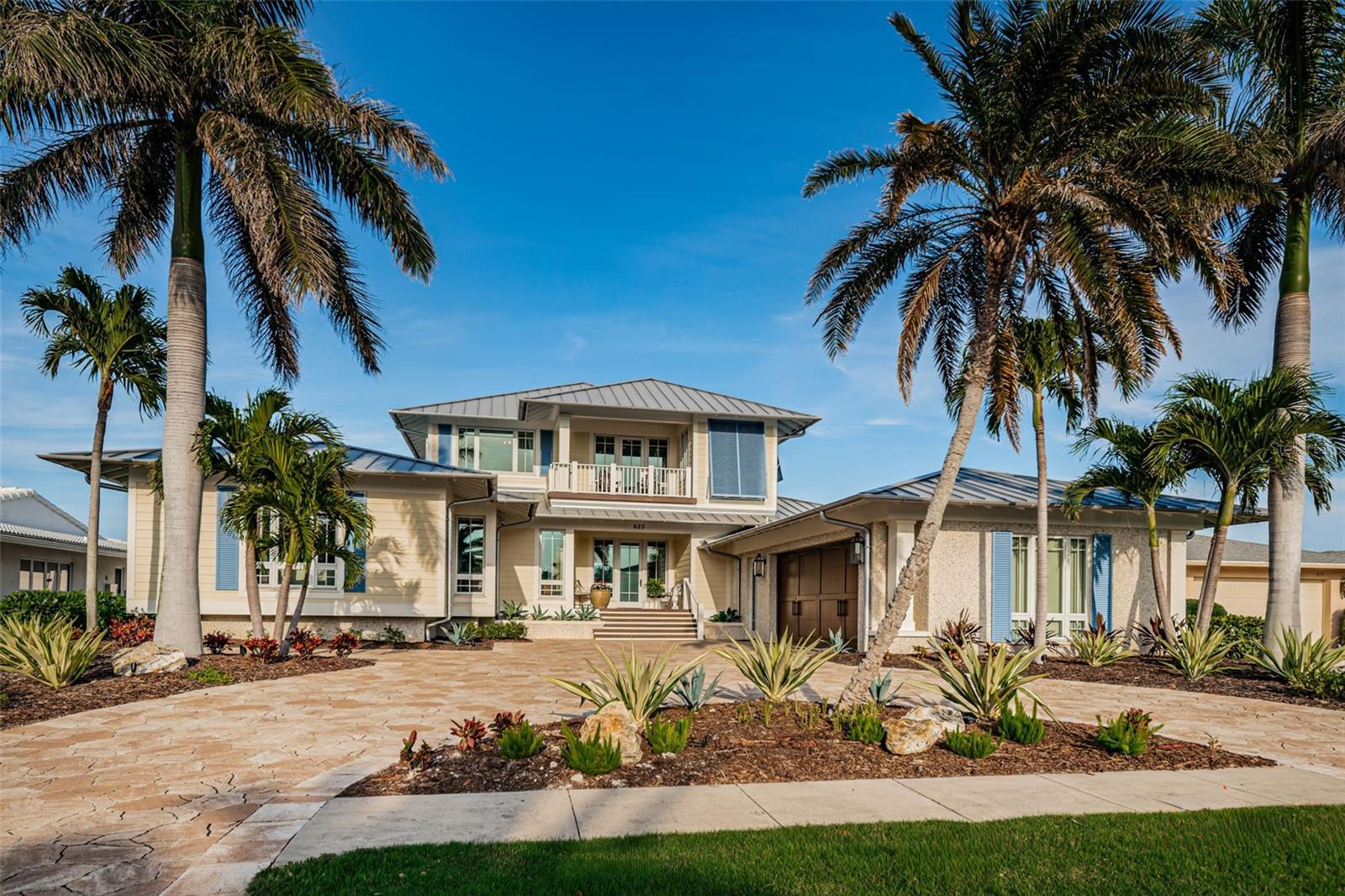 Welcome to paradise living at its finest! Nestled along the serene waterfront of Island Estates, this luxurious Key West style home offers a lifestyle of elegance and convenience. Custom-built by a local general contractor, no expense was spared in crafting this masterpiece, ensuring the ultimate in comfort, security, and style. Additional unseen features include, multi-point secured exterior doors, metal duct work, duct smoke detectors, whole house audio system, media control closet & surround sound & more! From the moment you arrive, you'll by greeted by breathtaking, unobstructed views of Clearwater Harbor! Designed with the upmost attention to detail, this home is not only stunning but engineered to withstand the forces of nature. Professional engineering for hurricane wind zones, extra hurricane strapping, and hurricane impact glass provide peace of mind during any storm season! Before we head inside take a peek at the custom, oversized garage with workshop & polished concrete floors! Step inside and you will love the seamless blend of indoor and outdoor living, high ceilings with custom built-in finishes, seamless flooring throughout, and Custom Window Treatments! The Living room, Dining room, & Kitchen share an open concept feel to not miss a hint of the views and provides an easy flow for entertaining. Now let's talk Chef's Kitchen, featuring Quartz Countertops, a Center Island w Sink, Wolf Range & Hood, Pot Filler, Sub Zero Refrigerator, Farm Sink, Insta Hot, Touchless Faucet, Custom Cabinets & an Island for sitting! There is also a walk-in closet Pantry with tons of space! The Primary Bedroom is a true sanctuary with accented Coffered Ceiling, spectacular views from your cozy sitting area, & spacious walk-in closet. The Primary Bath has a dual Sink Vanity with Quartz Countertop, walk-in Shower, & soaking Tub! Moving along on the first floor you have an amazing Guest Suite where a lovely sitting area, En-Suite Bath, and added Kitchenette showcasing Quartz Countertops, Sink, & Sub Zero refrigerator await you! There is also an Office & Laundry on the first floor, with a Powder room as well, and you will love the additional "Boat Room" for all your fishing supplies! Heading upstairs you are greeted with a HUGE BONUS ROOM! This room brings entertaining to a new level! There is a front Balcony for gorgeous sunset views, a wet bar, plenty of space for an exercise area and more! Upstairs hosts Bedroom 3 & 4 and the 3rd Full Bath! We saved the best for last! Stepping onto the outdoor deck area is a dream, several levels with plenty of space to enjoy the gorgeous views, including an Outdoor Kitchen with Wolf Grill & Hood, Sub Zero Refrigerator & Dining space! Or spend your day floating away in your beautiful saline pool & spa, or take cover under your Pergola and enjoy the fire! Last but not least, the incredible Dock that holds not one, but 2 boats! Complete with Trek decking, two 50 amp pedestals, sink w fish cleaning station and a boat lift! Some additional added features include: Outlets in the Soffits for holiday lighting, water softener, Hot water circulation system w timer, Remote controlled water and gas valves, Decked garage attic space, Extra Height Garage Doors, Raised Garden Bed supplied with fresh water irrigation zone, lifetime warranty Pebble Tec Pool, AND ASSUMABLE FLOOD POLICY! Short distance to Clearwater Beach, shopping, hospitals & houses of worship. Room sizes are approximate & should be verified by buyer.