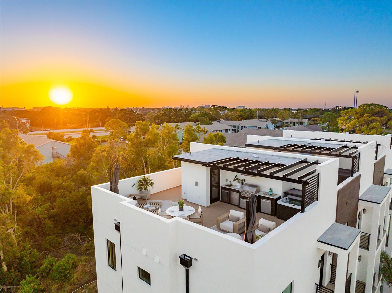 At last, the exquisite 20-unit Baypoint Luxury Townhomes development is ready for you to call home. This modern oasis offers you the chance to be part of an exclusive community where style meets comfort. Each around 1,800 sq. ft. residence features three bedrooms, two and a half elegant bathrooms, and the unique convenience of a four-car garage. The open-concept kitchen and living area provide a seamless space for both relaxation and entertaining, highlighted by sleek Samsung Bespoke appliances and exquisite Calacatta Quartz countertops. Imagine unwinding on your private rooftop terrace with a 6-seater spa, complete with Bluetooth speakers and ambient LED lighting. The outdoor kitchen, equipped with an outdoor kitchen and custom pergola, promises endless culinary adventures. Built with impact-rated windows and doors, custom powder-coated railings, and BLOCK AND BLOCK construction, these homes are as impressive as they are functional. Enjoy lush landscaping with St. Augustine sod, all for an HOA fee of just $102 a month. Plus, take advantage of the 2-1 buy-down concession for potentially lower interest rates. Perfectly situated between Downtown Tampa and St. Petersburg, and just a short drive from world-renowned beaches, Baypoint Luxury Townhomes offers an unmatched lifestyle of elegance and convenience that you won't want to miss.
