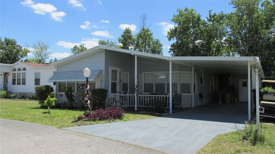 This 1991 Homes of Merit is situated on the perimeter of this lovely community in a hard-to-find location, woods and wetlands. The Florida Room is located in the back of the house, so you have a wonderful view of the woods and wildlife. No construction behind you.  The master suite is a king size room with a large walk-in closet. The master bath has a step-in shower; all tile with multiple shower heads. All new.  The guest room is a comfortable area for your visitors. Roof was replaced in 2023, A/C unit is older but has been serviced annually. The front lanai has been converted into part of the house/living room area, giving you plenty of space for entertaining. The plumbing has been updated, no gray pipe. The community is a very active one, with many amenities to choose from for your relaxation and enjoyment.