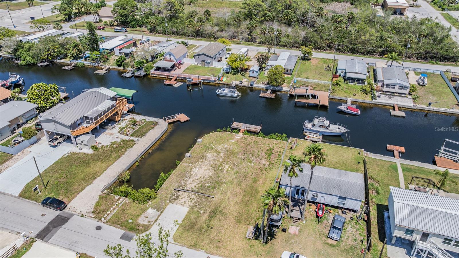 Under contract-accepting backup offers. Fabulous oversized DOUBLE LOT on the canal with Gulf Access, no bridges! With 110 feet of sturdy seawall, a floating dock, dual davit platforms and rubberized sport matting already in place, and direct canal access to the Gulf of America, it's a boaters dream! Take the boat, kayaks or paddle boards and start living the salt life. NO DEED RESTRICTIONS SO bring the water toys or keep your RV here. Make a boat barn, RV garage or an epic fire pit. There was a home here previously so no impact fees if you build your waterfront home! Public water and sewer. The home across the street (13039 Keel Ct) is also for sale. Purchase both and get an exceptional discounted price. Use both properties in conjunction with each other, the sky is the limit! We have a loan offer that does vacant land loans.