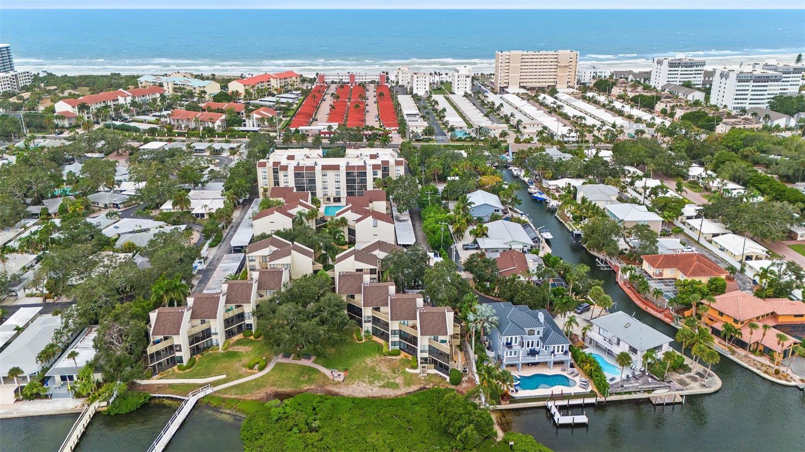Price Improvement! Don't miss out on the opportunity to own this spacious condominium in the rarely available Bay Oaks community on Siesta Key. This condo comes fully furnished and turnkey, making it perfect for personal use or as a lucrative investment with weekly rental potential with future bookings in place. Relish the Gulf breeze from one of your three balconies, each offering partial Intracoastal water views. The two bedrooms, each equipped with own private bathroom and walk-in closet, are located upstairs. The master bedroom boasts a private balcony with stunning water vistas, while an additional private balcony is nestled between the two bedrooms. The living room features a screened-in balcony with water views, thoughtfully updated with crown molding, new appliances, and delightful furnishings in excellent condition. Also provided is the convenience of in-unit laundry with additional storage space and a half bath on the lower level. The monthly fees are among the most affordable, covering water, sewer, roof maintenance, cable, pest control, exterior upkeep, and access to fantastic amenities like a heated pool, tennis courts, outdoor waterfront grilling, island shuttle bus services, and a fishing dock in a serene park-like environment. A short stroll away, you'll find the renowned white sandy beaches of Siesta Key and the vibrant Village, offering an array of dining and shopping options. This is your chance to own a slice of paradise!