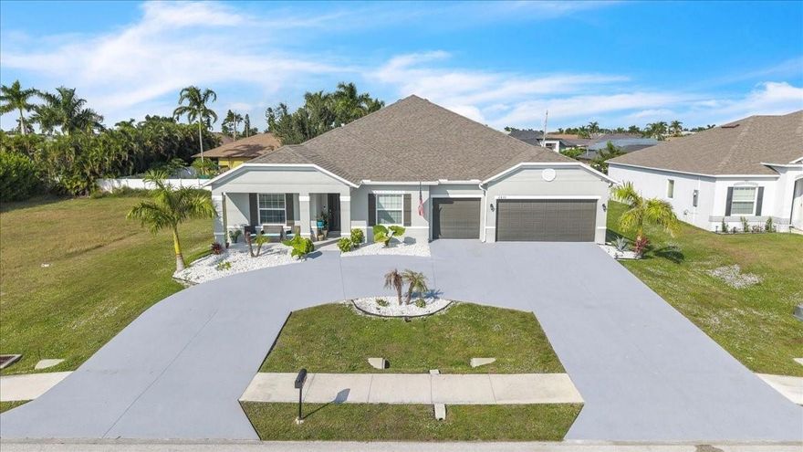 ***Motivated Sellers! Massive Opportunity Alert*** Looking for serious space and an unbeatable value? This is one of the only homes in Cape Coral offering 3,000+ sq ft for under $550K—a rare find in today’s market! Step into this stunning, like-new 2023 modern masterpiece, perfectly situated in one of Cape Coral’s most desirable areas. With over 3,000 square feet of flexible, usable living space, this home is bursting with potential—ideal for large families, multigenerational living, in-laws, home offices, or anyone craving room to grow. Featuring 4 bedrooms, den, flex room, and 3 full baths, this thoughtfully designed layout delivers unmatched versatility. Enjoy multiple living zones, private bedroom wings, and abundant open space for gathering, relaxing, or creating the lifestyle you’ve been dreaming of. The expansive great room shines with soaring ceilings, tile throughout, and an open-concept design that feels bright, fresh, and modern. The upgraded chef’s kitchen is an entertainer’s dream—complete with a massive island, granite countertops, double oven, cooktop, breakfast bar seating, and extensive cabinetry. The luxurious primary suite offers a peaceful retreat with tray-vaulted ceiling, private lanai access, and a spa-style bath featuring a soaking tub, walk-in shower, and dual vanities. The guest wing is perfect for large or extended families, with two bedrooms, walk-in closets, a bonus area, and a dual-vanity bath. The fourth bedroom sits near a third full bath with glass shower doors, while a den and flex space offers endless possibilities—extra bedrooms, offices, playrooms, formal dining or even an in-law suite. Outdoor living shines with an oversized screened lanai, inviting front porch, beautiful landscaping, and room for a pool. The 3-car garage includes epoxy flooring. A spacious laundry room with cabinets, sink, and folding counter adds everyday convenience. Whole-house surge protection. ASSUMABLE FLOOD POLICY included for added value. Surrounded by newer homes and just minutes from saltwater canals, parks, marinas, top-rated schools, restaurants, shopping, and beaches. This move-in-ready home offers space, flexibility, and prime location for the demand of todays buyers.