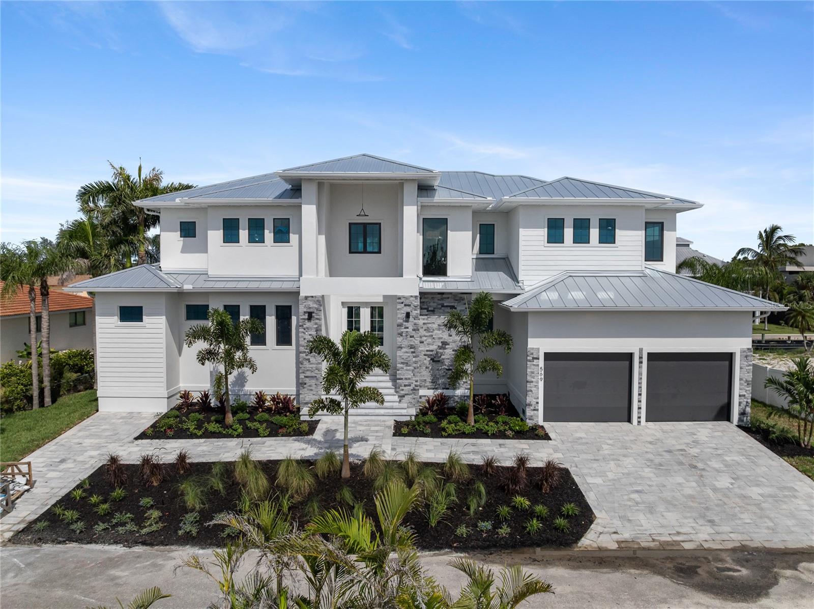 Under Construction. New Construction. Experience the pinnacle of waterfront luxury with this brand-new construction home in the heart of Longboat Key competitively priced and ready for its next owner. Situated on a private canal, this 4-bedroom plus den, 4,106 sqft residence offers the perfect blend of modern elegance and coastal charm. Designed for seamless indoor-outdoor living, the home features two lanais, a private pool with a spa, and an elevated foundation at 9.5 feet. Boating enthusiasts will appreciate the 10,000-lb boat dock and quick access to the Gulf of Mexico for endless days on the water. Inside, enjoy engineered hardwood flooring throughout, quartz countertops in every space, and a large walk-in pantry. The thoughtfully designed layout includes two laundry rooms for added convenience. Nestled in a quiet, private setting, yet just minutes from Longboat Key’s pristine beaches, golf courses, and fine dining, this home is a rare find. Don’t miss the chance to own a waterfront masterpiece in one of Florida’s most desirable locations.
