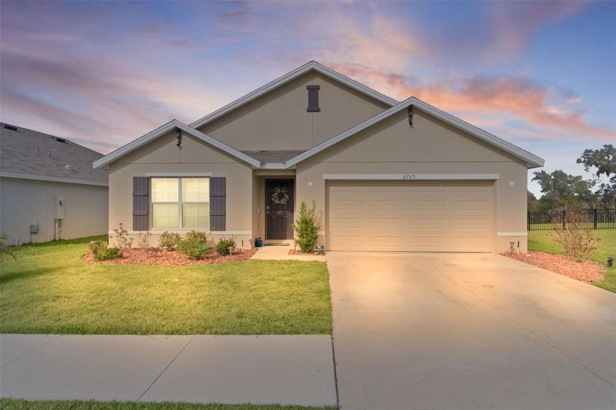 Check out this modern, move-in-ready home located in the highly sought-after Southeast Division of the Deer Path Community. Built in 2023, this 4-bedroom 2-bath Cali Model home has it all. As you approach this home, take note of the manicured lawn with rocked landscape. This home features a spacious open floor plan with tiled flooring in main living area. The kitchen features white cabinetry with granite counters, stainless appliances, and a large, functional kitchen island offering ample prep space and additional seating—perfect for everyday living and entertaining. The primary bedroom features a walk-in closet and an ensuite bath with dual sinks and a walk-in shower. Three additional bedrooms provide plenty of space for a growing family, visiting guests, or a home office. The laundry room features cabinets above the appliances for additional storage. Enjoy outdoor living with a covered lanai and extended paver patio with a fenced yard which backs up to a retention pond. Another great feature of this home is the smart home technology that operates the A/C, garage door, front door lock, lights and more! All controlled on a free app on your phone. The home surge protection system protects appliances and electronics from power surges and spikes