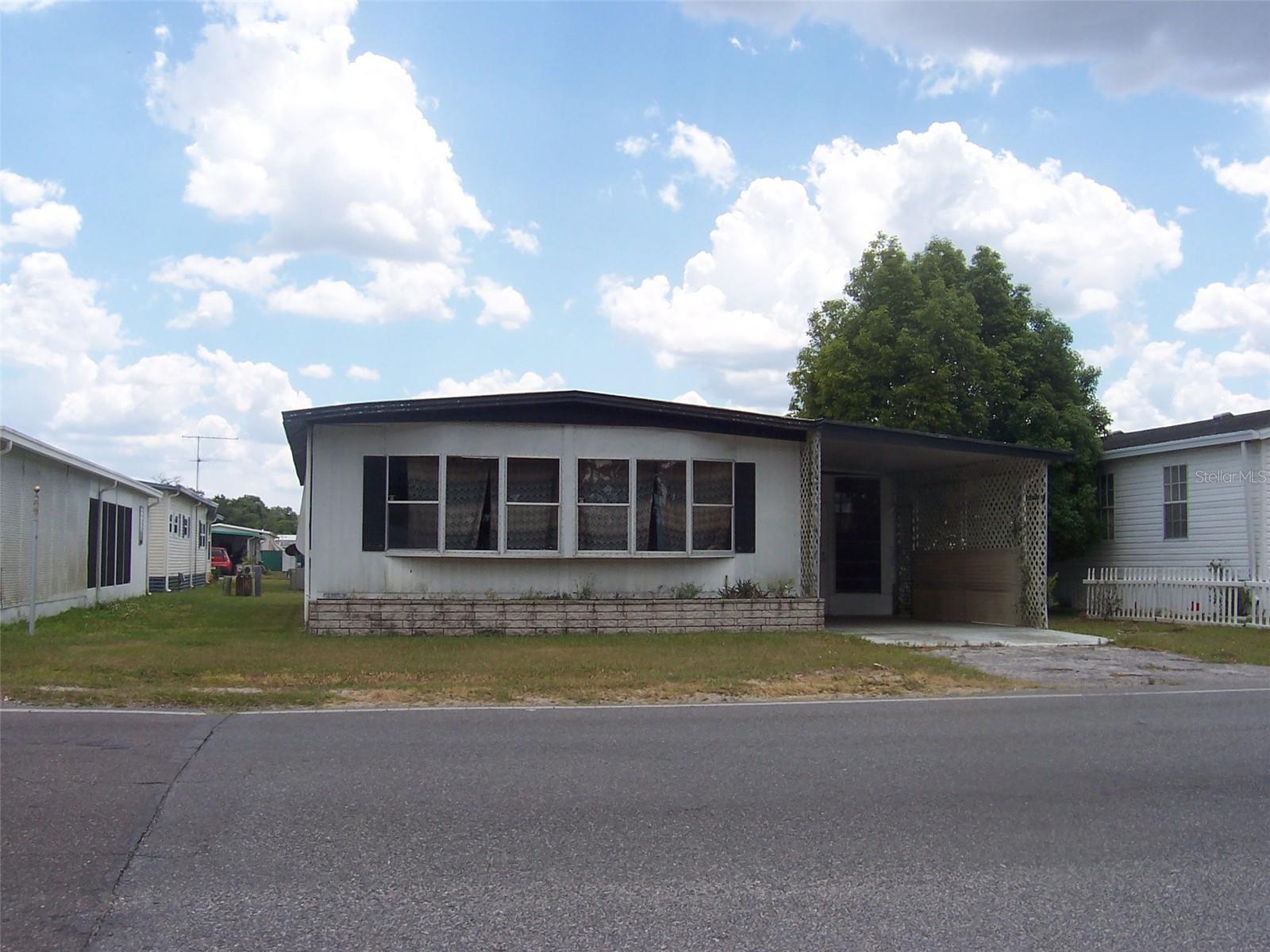 COMPLETE REHAB!!! CAN'T SAY THAT LOUD ENOUGH!! RECENT PRICE REDUCTION! Great floor plan with Family room and Living Room. 2 bedrooms and 2 baths. Needs MAJOR interior and exterior repairs. Floor however is very solid and appears to be completed with plywood. Spacious screen room and tremendous workshop space with laundry room inside. Located in a 55+ park with great access to big box stores, grocery stores, hospital and Doctors office. This is a great opportunity for an investment, rental or homeowner. HOA is optional however deed restrictions still apply! This is not just a fluffy fixer upper - this is a complete rehab!