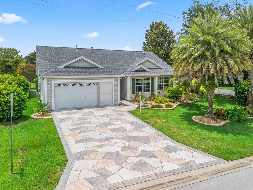 Paradise awaits in the charming Village of Springdale, where elegance meets tranquility in this exquisite Whispering Pine model home. Featuring 3 bedrooms and 2 bathrooms, this well-crafted home is a true testament to fine living.  From the moment you arrive, you'll be impressed by the picture-perfect curb appeal, featuring professionally landscaped grounds and a Stamped Concrete driveway & walkway. The landscaped exterior showcases Stacked Stone-framed rock beds with Palm trees creating an impressive curb appeal. As you step inside, you’ll appreciate the absence of carpeting and the sleek flooring that creates a seamless, modern feel throughout the home. The Kitchen features Granite Counters, Stainless Appliances, French Door Refrigerator w/water & ice in door, Recessed Lighting and Breakfast Bar. This kitchen also includes a generous breakfast nook with windows for lots of natural light. The Primary Bedroom is located in the back corner of the home for maximum privacy. This spacious Primary Suite includes High Ceiling, large closet and a bath with double vanities and step-in shower. Bedrooms two and three (No Closet) are located in the front corner of the house and share the Guest Bathroom which has a Tiled Shower/Tub combo and Granite Counters. There is a Hall Linen closet. Enjoy the added bonus of an enclosed lanai with Tile flooring, offering a peaceful retreat with views of a picturesque walking trail that will inspire relaxation and rejuvenation. A Stamped Concrete patio provides the perfect spot for outdoor grilling. Just beyond your door, you’ll find the community pool, offering the perfect spot to unwind with a swim or simply bask in the Florida sun. Perfectly located close to Spanish Springs Town Square and Lake Sumter Landing, this home offers the ideal balance of convenience and leisure. Whether you’re drawn to the lively entertainment and shopping or prefer the peaceful strolls along the waterfront, Springdale provides the best of both worlds right at your doorstep. This property is in an ideal location; with a short golf cart ride you are just moments from the Springdale Pool, Dog Park, Mulberry Grove Pool & Regional Recreation Center, the Nancy Lopez Country Club, the First Responders Regional Recreation Center and Mulberry Grove Shopping Center offering Grocery, Drugstore, Banking, Medical, VA Center, Restaurants etc. You will also enjoy Lots of options for golfing, entertainment at the Savannah Center, dining at the Nancy Lopez Legacy Country Club, the Glen View Country Club, and much more. So, what are you waiting for… Don’t miss your chance to own this beautiful Whispering Pine model. Experience The Village lifestyle you’ve always dreamed of in Springdale—where comfort, convenience, and charm await. Schedule your private home tour today! A QUICK CLOSE is available so you can be enjoying The Villages lifestyle soon! New Roof 2020, Water Heater 2022, HVAC 2015. Room Measurements and Square Footage are approximate and should be verified by buyer/buyer’s agent. All information is deemed reliable but not guaranteed.