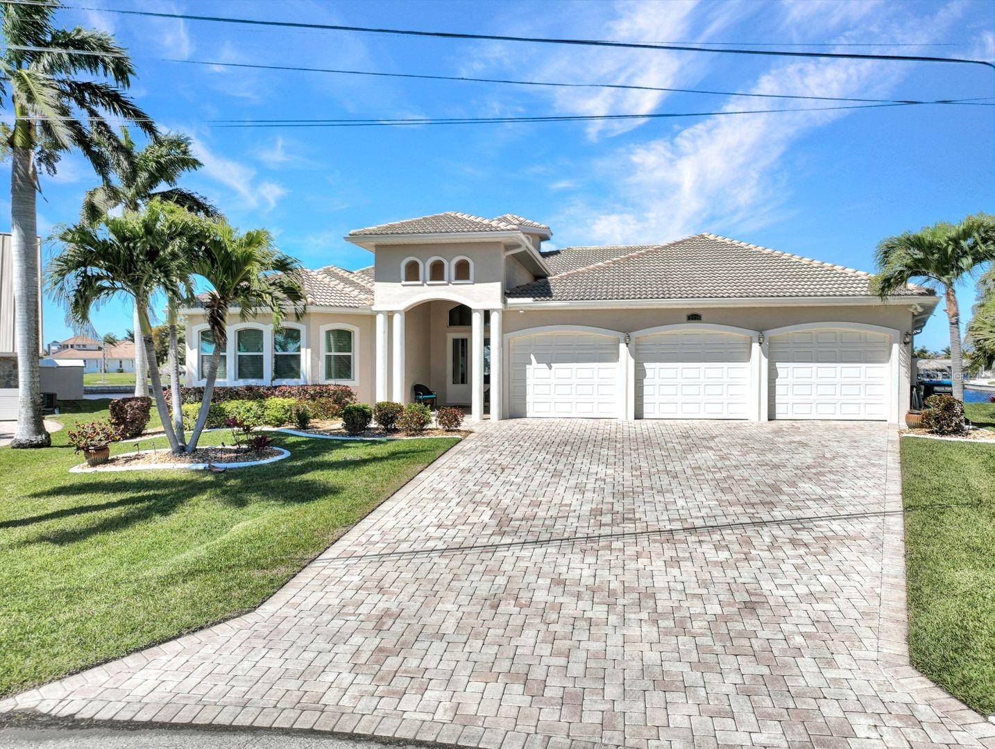 GULF ACCESS - BASIN VIEWS! Built in 2014 everything about this custom luxury home is GRANDE! Not 1, not 2, but 3 Owners suites PLUS 3 additional bedrooms with en-suite bathrooms. Situated on oversized lot with western and northern exposure over 150 ft of waterfront, featuring intersecting canal and basin views that will be the highlight of your day. Over 4200 sqft of living space comes turnkey furnished and includes 6BR, 6.5BA and a 3 Car Garage. Great room floor plan with split bedrooms ensures privacy and can accommodate a large family full time or vacationing. This home offers IMPACT WINDOWS/DOORS, granite counters, tile and hardwood flooring, seamless shower doors, dual sinks, volume/trey ceilings and crown molding throughout. Kitchen is central and features pass through to outdoor living. The outdoor living begins with covered lanai, summer kitchen, and roll down shutters for added peace of mind. Take a dip in the 40 foot sparkling blue pool with cascading waterfall spa or sun yourself on one of the sun decks and take in the vast wide water views. Bring your boat and enjoy the composite captians walk and multiple areas to park your boat, jet skis, kayaks or paddle boards. Cast your fishing line and enjoy a cocktail waterfront while enjoying the breathtaking SWFL sunsets. SW Cape Coral is an up and coming area with premium boating and amenities enjoying NO HOA and NO RENTAL RESTRICTIONS. This home is absolutely spotless, meticulously cared for, built to stand the test of time, turnkey furnished with gorgeous finishes and is just waiting for you! See additional features, 3D tour or simply schedule your private tour today!