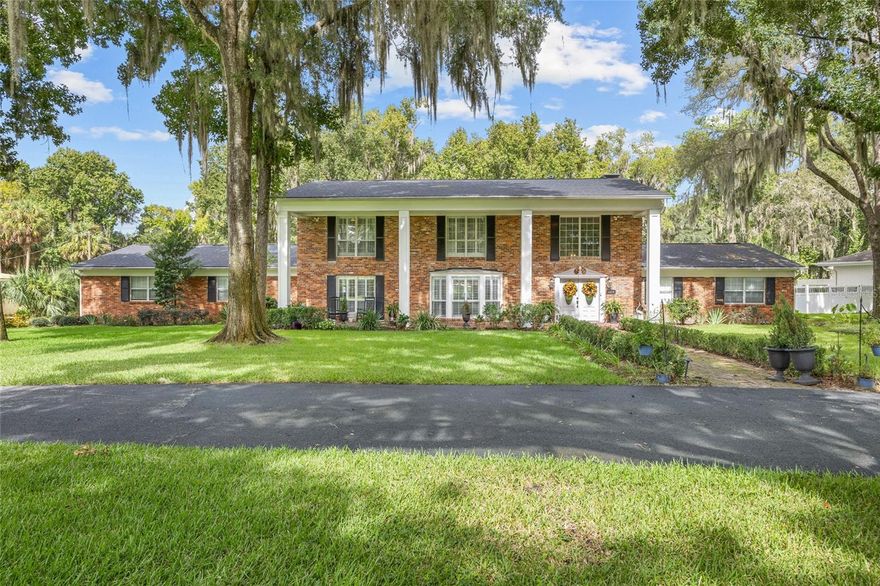 No expense was spared in this colonial charmer! Nestled in the heart of SW Gainesville on the Gainesville Golf & CC just minutes from UF on a circle drive corner lot. This home has the WOW factor at every turn from the grand two-story entry to the floor to ceiling brick fireplace in the primary bedroom and Wolf commercial grade gas range in the gourmet kitchen. It truly is a one-of-a-kind home in Gainesville. Recently remodeled including all new floors downstairs, complete kitchen redesign & much more! The expansive home has 5 bedrooms including both an upstairs primary suite complete with remodeled luxury bath and ensuite fireplace and a second story primary suite that also boasts a remodeled luxury bath. There are 3 additional bedrooms upstairs and a bonus room downstairs currently being used as a playroom. The home also features a formal dining room off the kitchen, a formal living room (which is being used as the dining room) and a large great room with a wood burning fireplace. The gourmet kitchen deserves its own zip code and is a chef's dream complete WOLF 6 burner + griddle Range, double in-wall ovens and subzero 36 inch fridge and OX ice machine. The french doors from the great room open up to an oversized lanai that overlooks the gorgeous backyard.