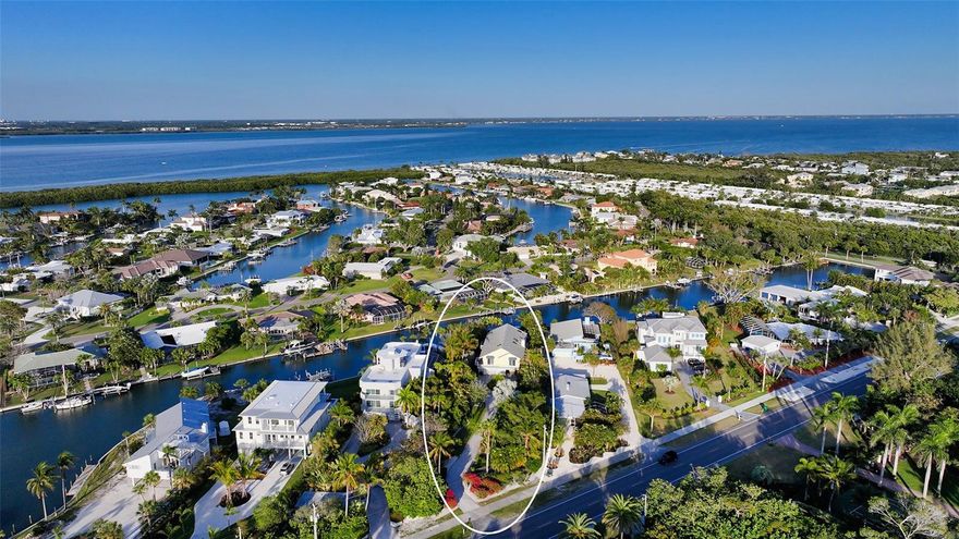 A gated entrance and paver driveway surrounded by lush landscaping leads to this lovely home on a wide canal that is a boater's dream. The location is a private half plus acre estate across the street from the beautiful Gulf of Mexico and beach. The exquisite double entry etched doors open to the first living level of storage and an elevator plus staircase that goes to the main level. The main living level features gorgeous wood floors, beautifully updated kitchen with granite breakfast bar that is open to the entertaining area with serene views over the wide canal waterway. All of the bedrooms have terraces. There is a caged pool and spa with an additional sunning area. This lovely canal home has been completely updated with the new gate and fence around property, major landscape work and premium sound system. The boater has direct intra coastal access. New seawall and dock installed in 2022.