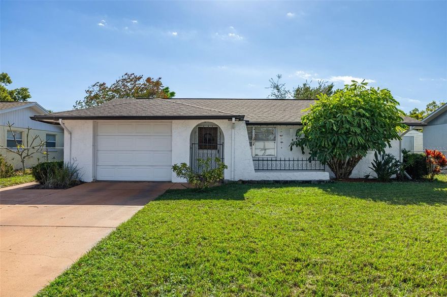Nicely Updated and Move-IN Ready 2 Bedroom 2 Bath 1 Car Garage 
Single family concrete block home. The spacious living room welcomes you upon entering, and the dining room shows off the gorgeous laminate flooring. The open kitchen offers plenty of counter and cabinet space, and custom backsplash. There is a screened lanai off the dining room accessed by a sliding glass door. The generous primary bedroom also has a walk-in closet, and the primary bathroom has been updated with a vanity with a marble top and custom flooring. Nice sized 2nd bedroom and 2nd bath is also updated. 
Roof was replaced in June - 2021.  A/C in 2025. Great location near to many shopping and dining options