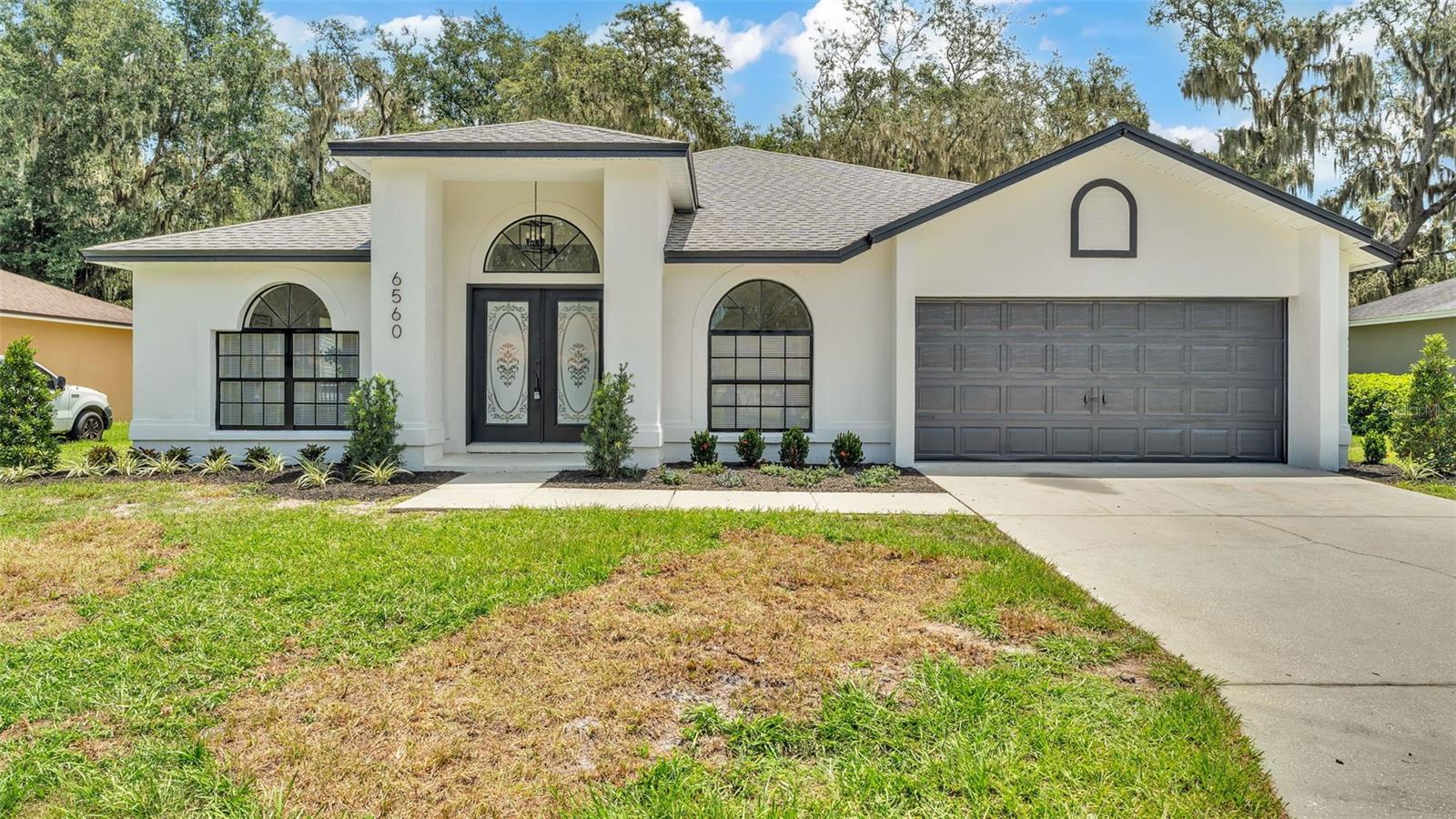 Beautiful 4 Bedroom, 2 Bathroom home, completely remodeled with a massive backyard with mature oak trees providing tons of shade! This home is completely move in ready and features a newer roof, new kitchen with stainless appliances and real quartz countertops, new luxury vinyl plank floors throughout, custom glamour bathrooms, black hardware and fixtures throughout, custom lighting, and much more! The home has a very open floor plan with a formal dining room and formal living room as well as a huge family room, and a true master suite complete with walk in closet. The 4th bedroom has double doors and would also be a perfect office, den or bonus room. The master bath has two separate vanities and a dedicated makeup area and oversized shower and a private toilet access. There are also walk-in closets in the master bedroom. There is direct access to the backyard from the master bedroom and a nice deck overlooking a backyard with an extra tall rear privacy fence! This property also features an oversized driveway and 2 car garage. This home is in an extremely sought after area and will not last long on the market. Schedule your showing today while it is still available!