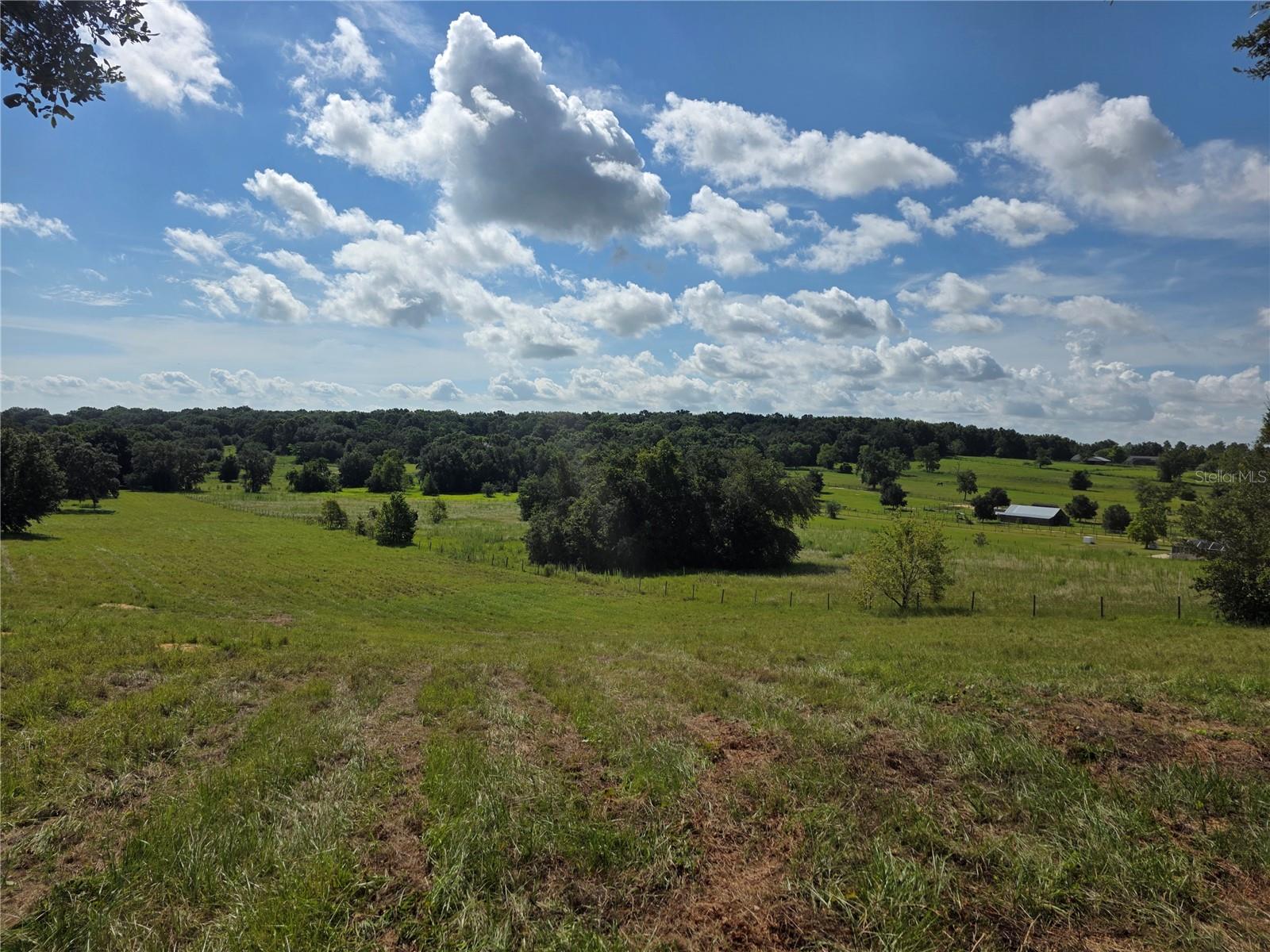 Embrace the opportunity to live your dream on Sugarloaf Mountain! This 5-acre lot is perfect for building your ideal retreat. It’s suitable for a hobby farm or to simply enjoy the freedom of having more space without the hassle of a homeowners association (HOA). The property is already fenced and cross-fenced and features a central aisle barn with three stalls and a tack room. Located near the top of Sugarloaf, you're just a few miles from the new Minneola/Hancock Road Turnpike exit. Explore nearby attractions such as Montverde Academy, the West Orange Trail, and Clermont Waterfront Park. Downtown Clermont is a short drive away, offering a farmers market, local shops, events, and more