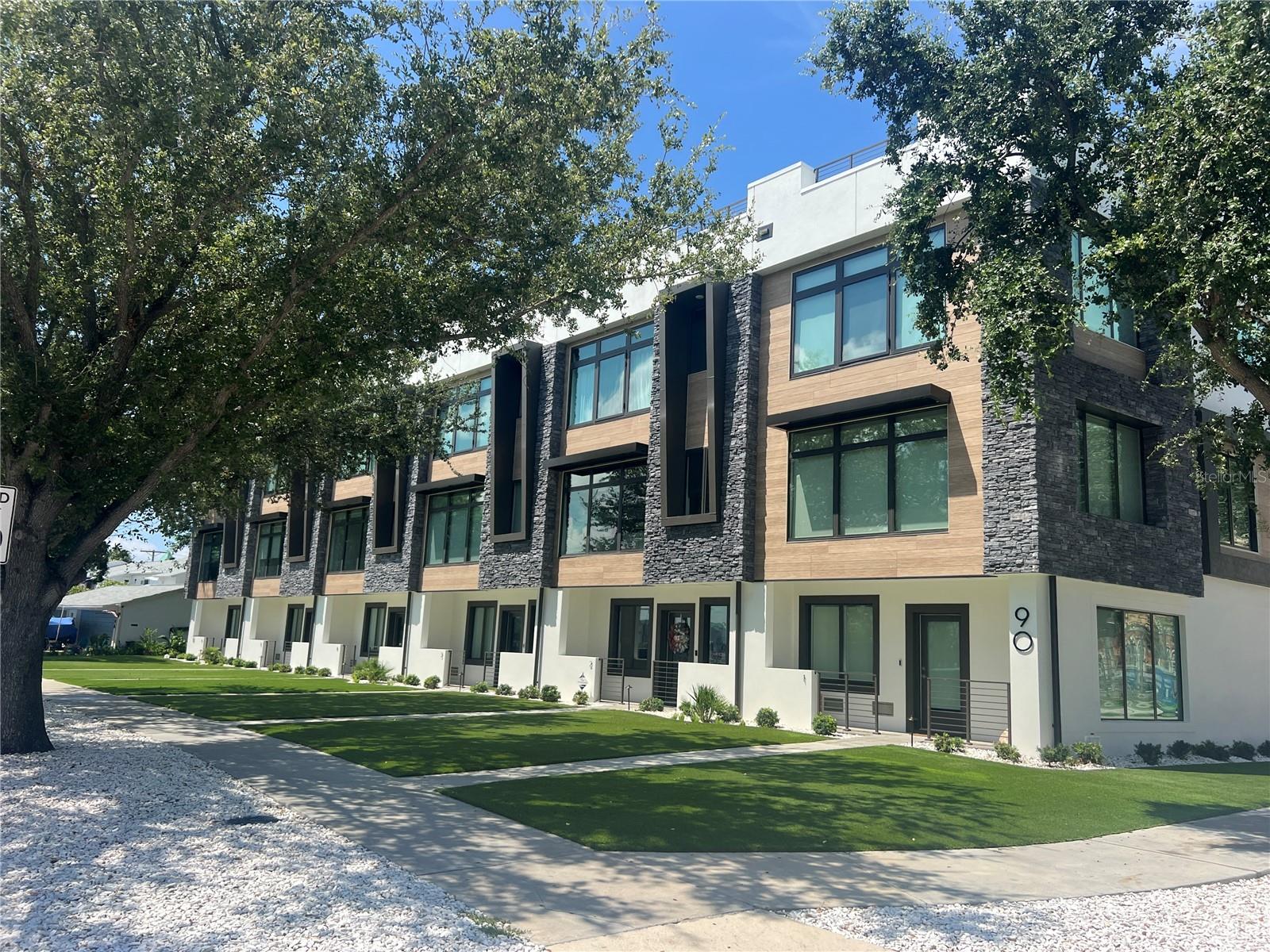 A stunning townhome located on the prestigious neighborhood of Davis Islands in South Tampa with WATERVIEWS. This 3 story townhome was just built in 2022 and spans 3,036 sq ft with 4 bedrooms, 3 full baths and a wonderful modern design.
The layout of this home features a large open floor plan, with high ceilings, cobalt white oak plank wood flooring, smooth drywall finish, and oversized picture windows throughout for enhanced natural light. The main living area offers a gourmet kitchen that includes expansive island, quartz counter tops, wood cabinets, stainless Viking appliances, including gas range and floating hood. Additional kitchen features include built-out pantry, custom built banguette, stand-alone ice maker and point-of-source water softener and purifier. While the kitchen is phenomenal so is the enhanced living room with custom wood frame accent wall, Restoration Hardware chandelier and a custom built bar that comes complete with a wine cooler, beverage fridge and granite counter top, all perfect for entertaining guests in style. Also on this level is a guest bedroom with full designer bath.
The third level houses the primary suite with fully finished walk-in closet, primary bath with dual vessel quartz countertop, oversized walk-in shower, soaking tub, LED back-lit mirrors and finished with Venetian plaster paint walls., built-in vanity tower and designer chandelier that adds a touch of opulence to the suite. There are two additional well sized guest bedrooms on this level, full guest bath, and utility room, with full sink, quartz countertops and storage.
The icing on this cake is the phenomenal rooftop, an entertainer’s dream, which offers panoramic views of Marjorie Park Yacht Basin, Seddon Channel, and the Downtown Tampa skyline. This outdoor oasis includes a fully equipped kitchen with granite countertops, large Al Fresco grill, beverage fridge, and ice machine. Relax by the permeant piped gas fire pit while taking in the stunning water and city views. This space is completed with a water feature, planters, and charming Edison string lighting, making it perfect for both daytime lounging and evening gatherings.
Every detail of this townhome has been meticulously and professionally designed including custom built closets, state-of-the-art Savant home automation system, a comprehensive security setup with Ring cameras and carbon/smoke detectors, full slat accent wall in entry with built-in mudroomLocated on the picturesque Davis Islands, this townhome offers an unparalleled lifestyle in a vibrant, walkable community favored by professional athletes, executives, and families alike. The neighborhood is home to a wealth of amenities, including Marjory Park Marina, the Sandra Freedman Tennis Complex, the historic Roy Jenkins pool, and Peter O. Knight Airport. A short stroll brings you to the Davis Islands Village, where you’ll find a variety of restaurants and shops. With its prime location just minutes from Downtown Tampa, Water Street, Sparkman Wharf, and the Tampa Riverwalk, this home truly offers the best of both island living and urban convenience. Additionally, it is situated within the boundaries of the highly rated Gorrie Elementary, Wilson Middle School, and Plant High School.