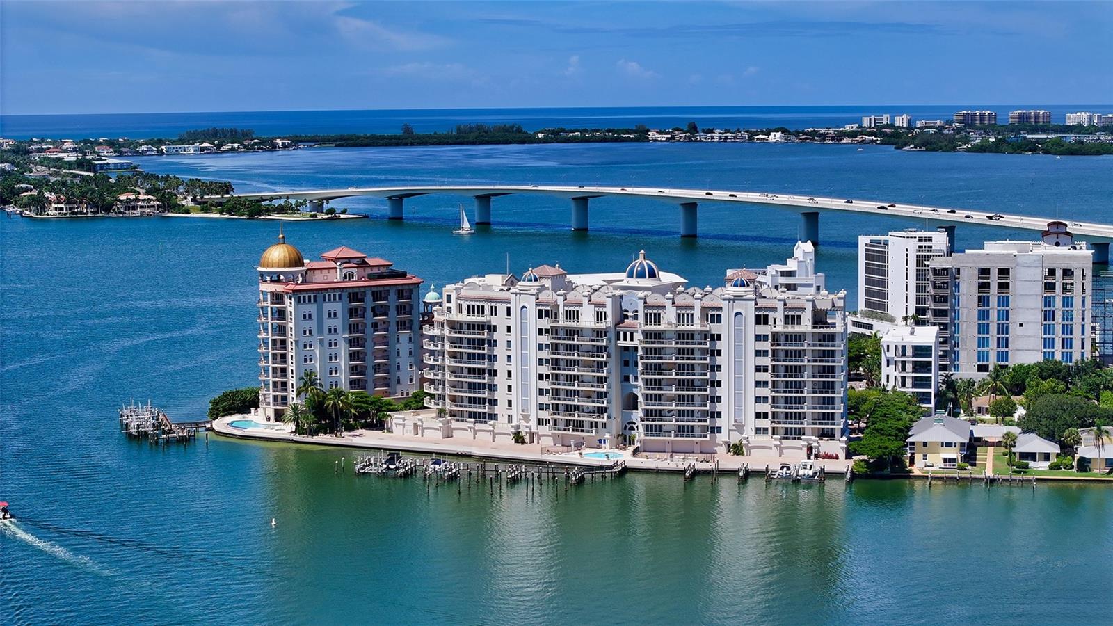 This 7th floor, 3 BR plus den, 4.5 bath residence located in La Bellasara, a direct bayfront boutique-size community set on Golden Gate Point, showcases outstanding, panoramic views of Sarasota Bay and sparkling city lights from every room. Take the private elevator to the double doors of the entry foyer, where stone floors meander the expanse of this 3,377 sq. ft. bayfront home with ceiling heights from 9 to 11 feet. The main living area provides the perfect setting for relaxation or entertainment with rich wood built-ins. An updated gourmet kitchen designed for both form and function features white custom cabinetry, top-of-the-line appliances,6 burner gas stove, center island & a walk-in pantry which all opens to the generous breakfast area, dining and main living area. Ease of entertainment continues on the 42 ft. bayfront terrace complete with a summer kitchen. For quiet reflection, retreat to the library with built-in bookcases & large enough for the occasional guest. The spacious, private master suite with 2 separate bathrooms & closets provides a morning bar for that cup of coffee as you step out to your bayfront terrace to watch the sunrise! Nicely set apart are 2 guest bedrooms with ensuite baths, custom built-in closets and terraces. A separate 2-car garage with extra storage positioned close to the elevator allows the feeling of living in your own private home without all the upkeep. Amenities include concierge services, heated pool and spa, fully equipped fitness center, theater, meeting & social room plus a courtesy day dock. La Bellasara is a gated, pet friendly community. Furnishings are available separately. Vacant easily shown.